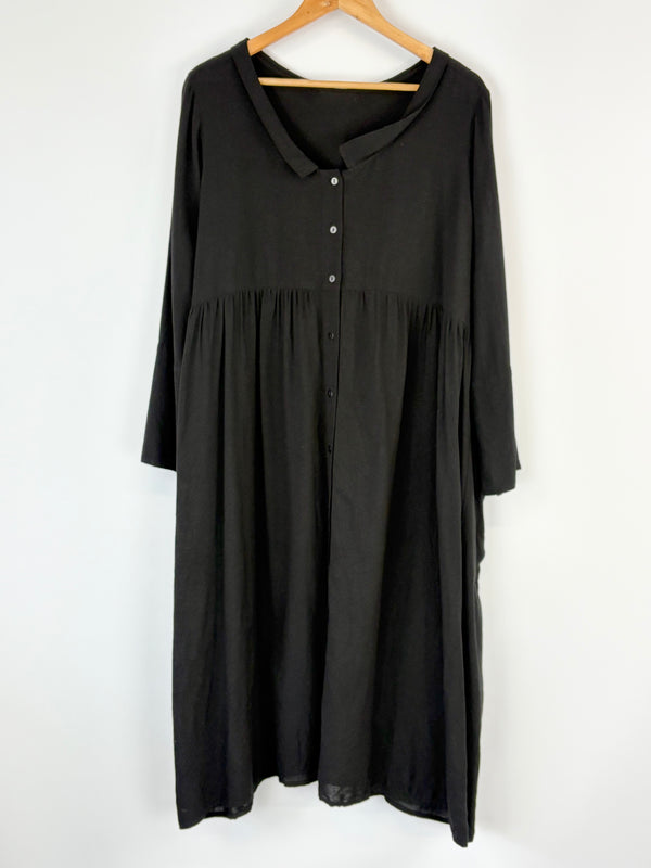 Black Barbara Lang dress on a hanger against a white background