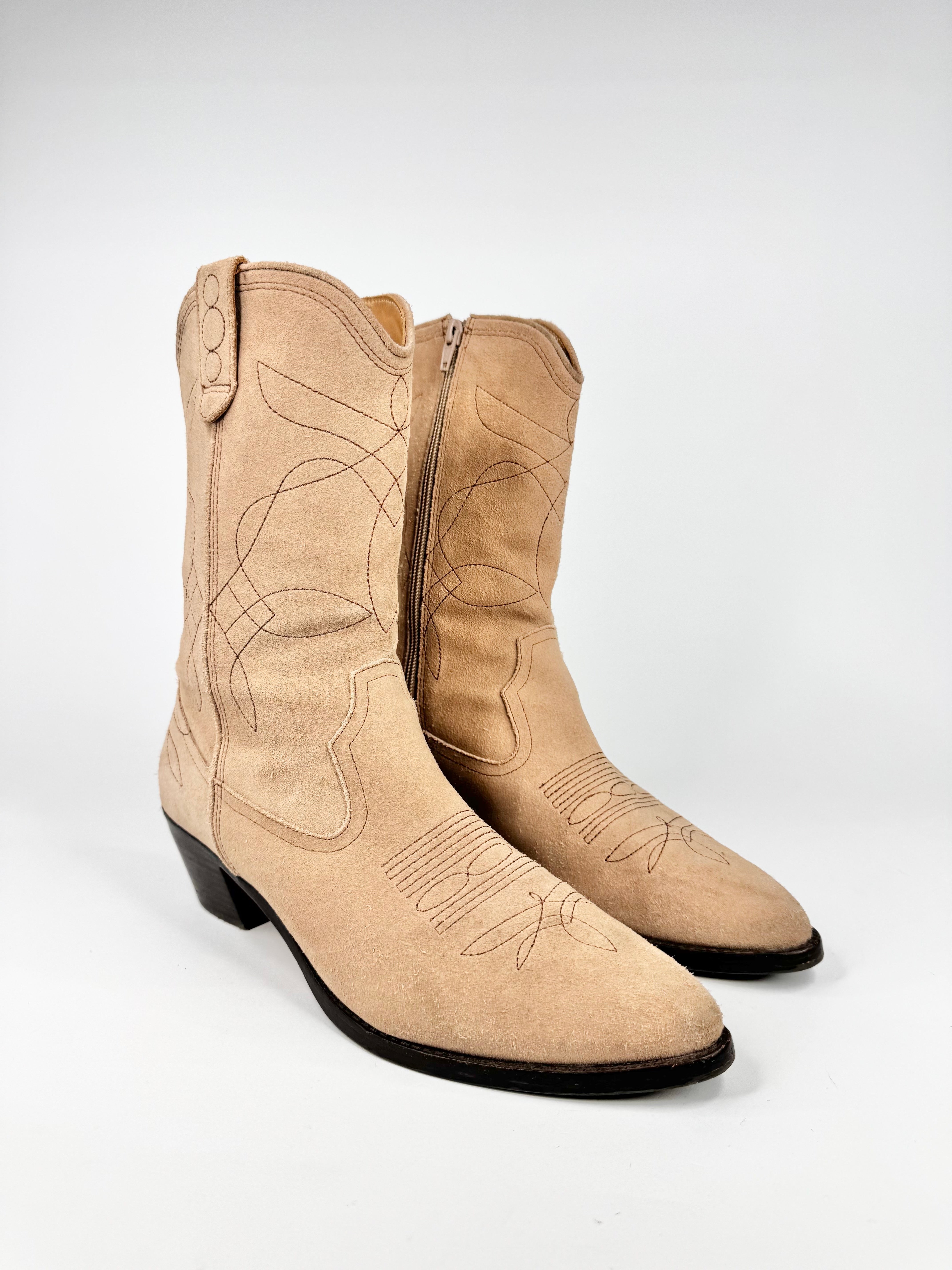 Pair of beige cowboy boots on a white background