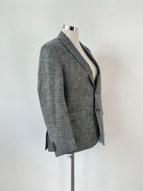 A sports coat with a modern fit, featuring a multicolour basket weave pattern on a mannequin against a white background.