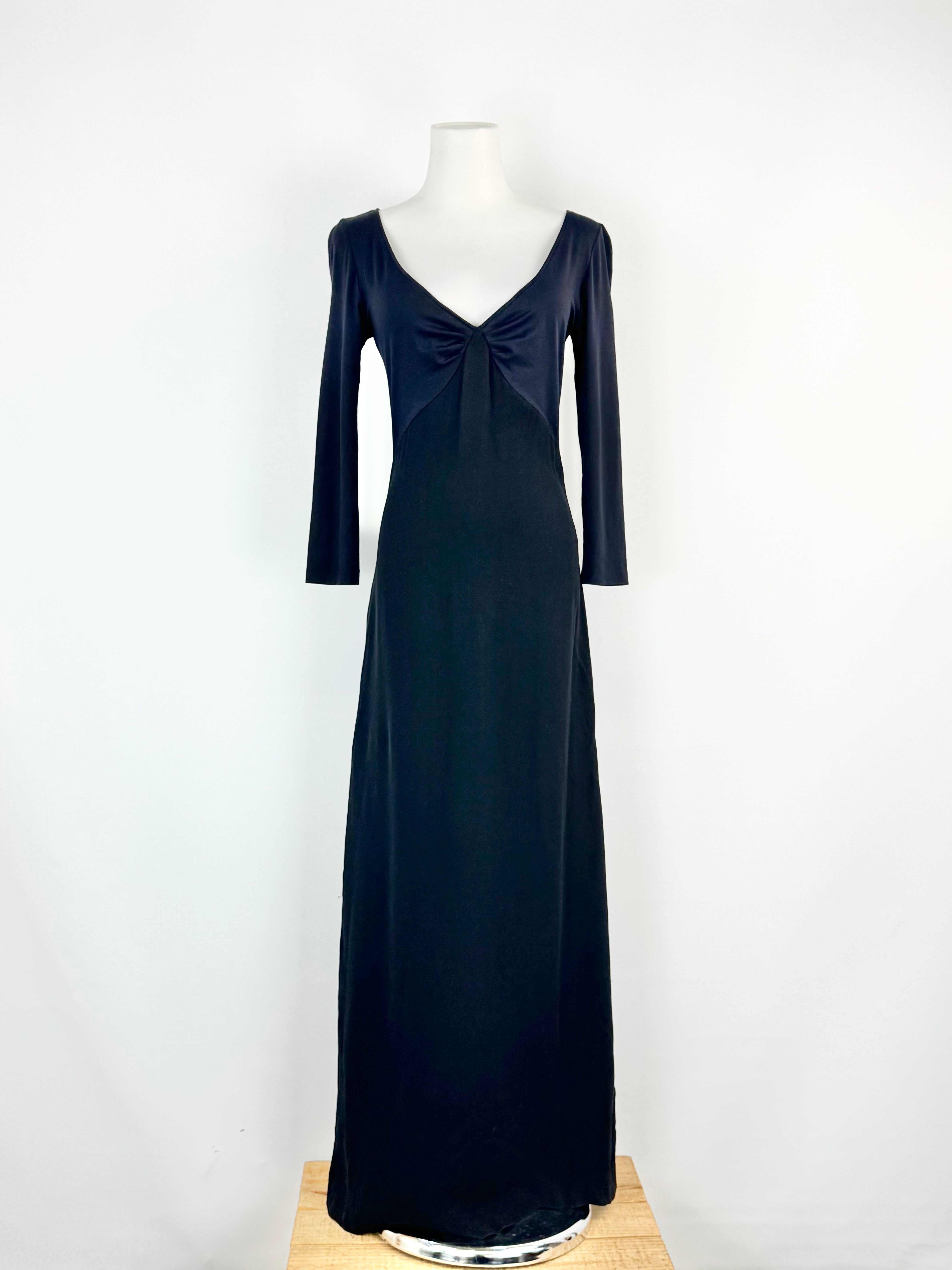 Black evening gown on a mannequin against a white background