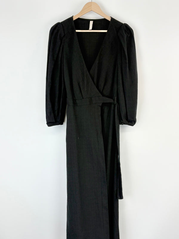 Black Bec + Bridge dress on a hanger against a white background