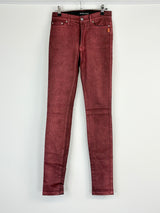 A pair of red tinsle coated skinny leggings on a hanger, displaying the front view.