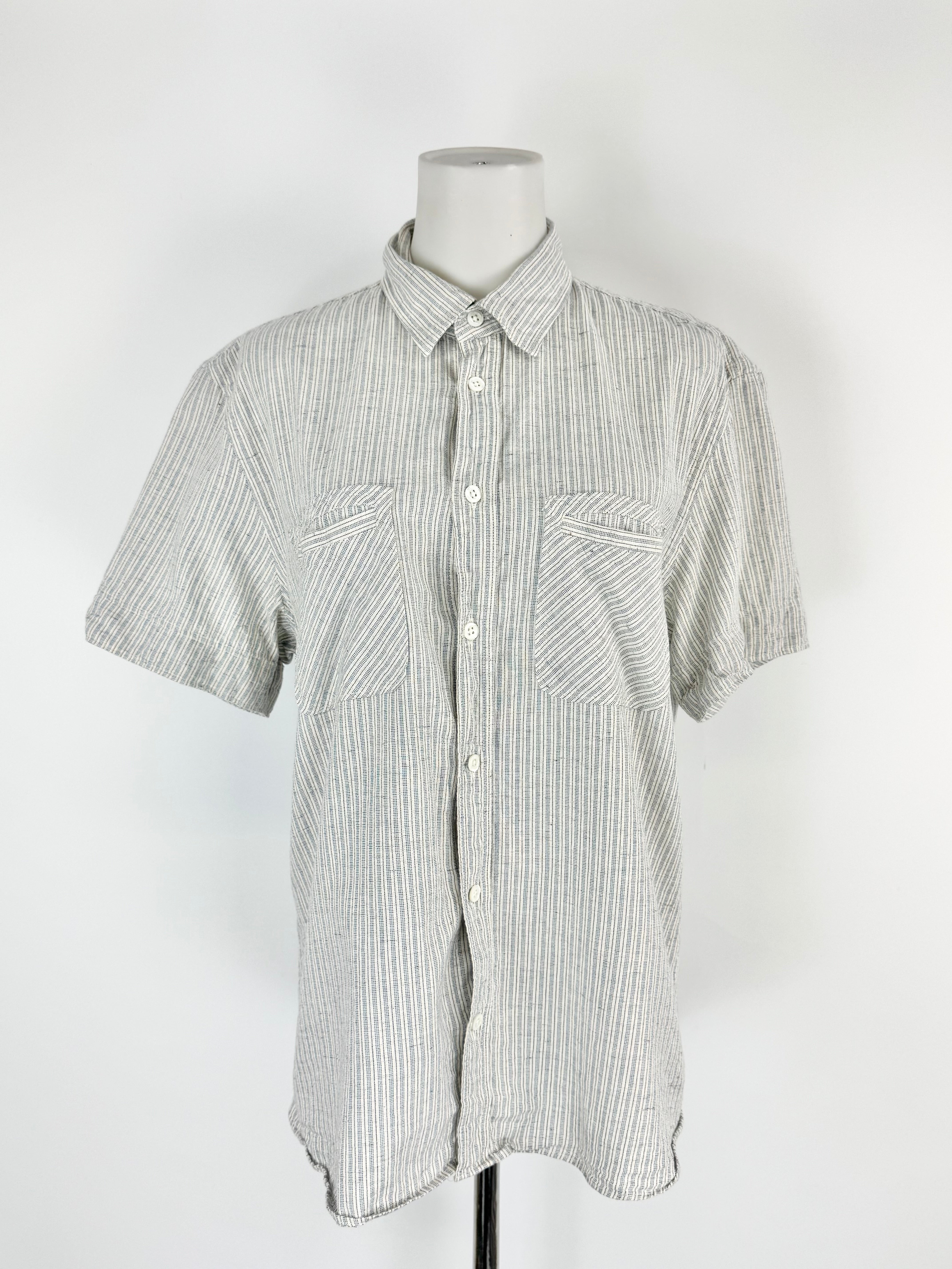 Short-sleeve button-up shirt on a mannequin against a white background