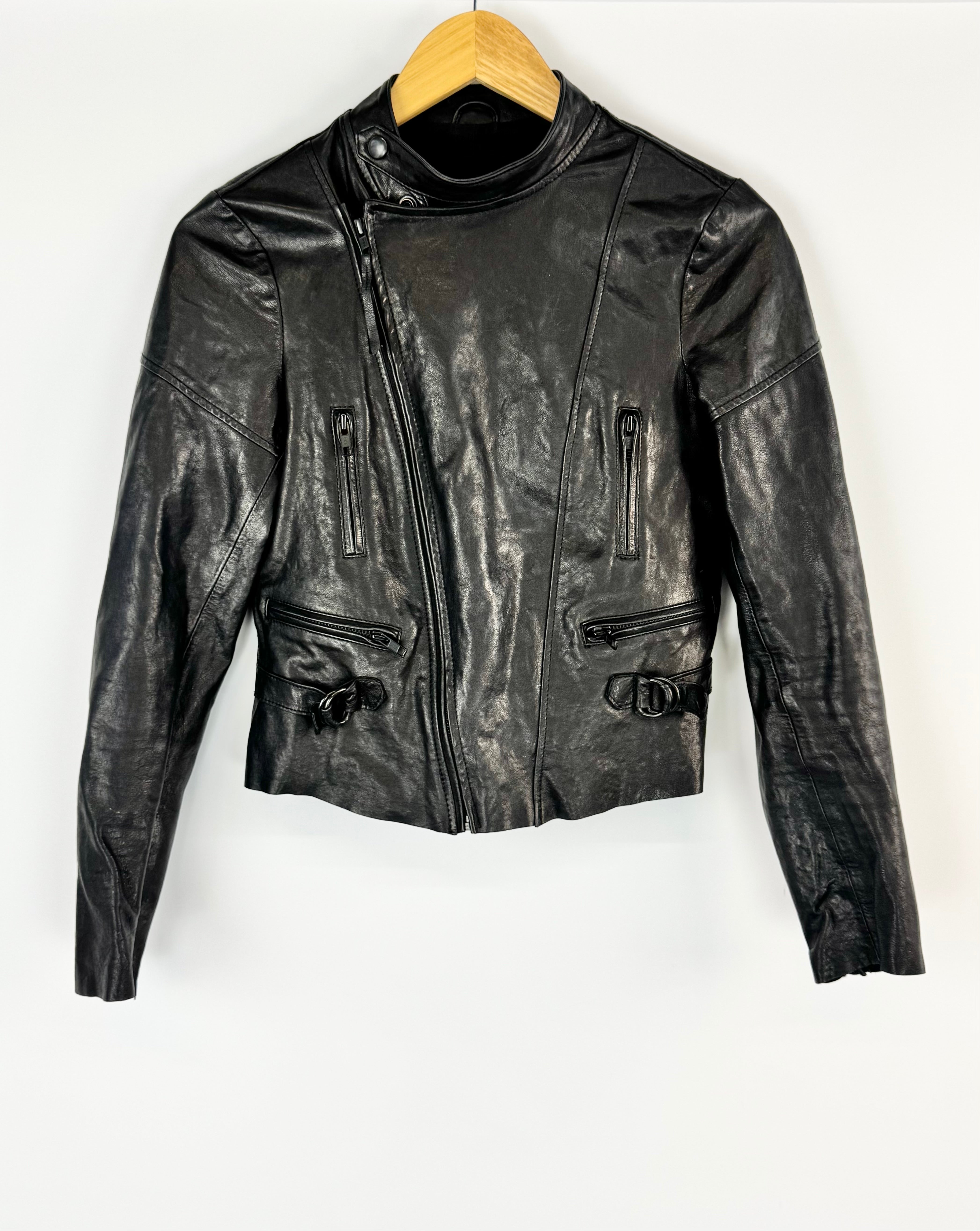 Black leather jacket on a wooden hanger against a white background