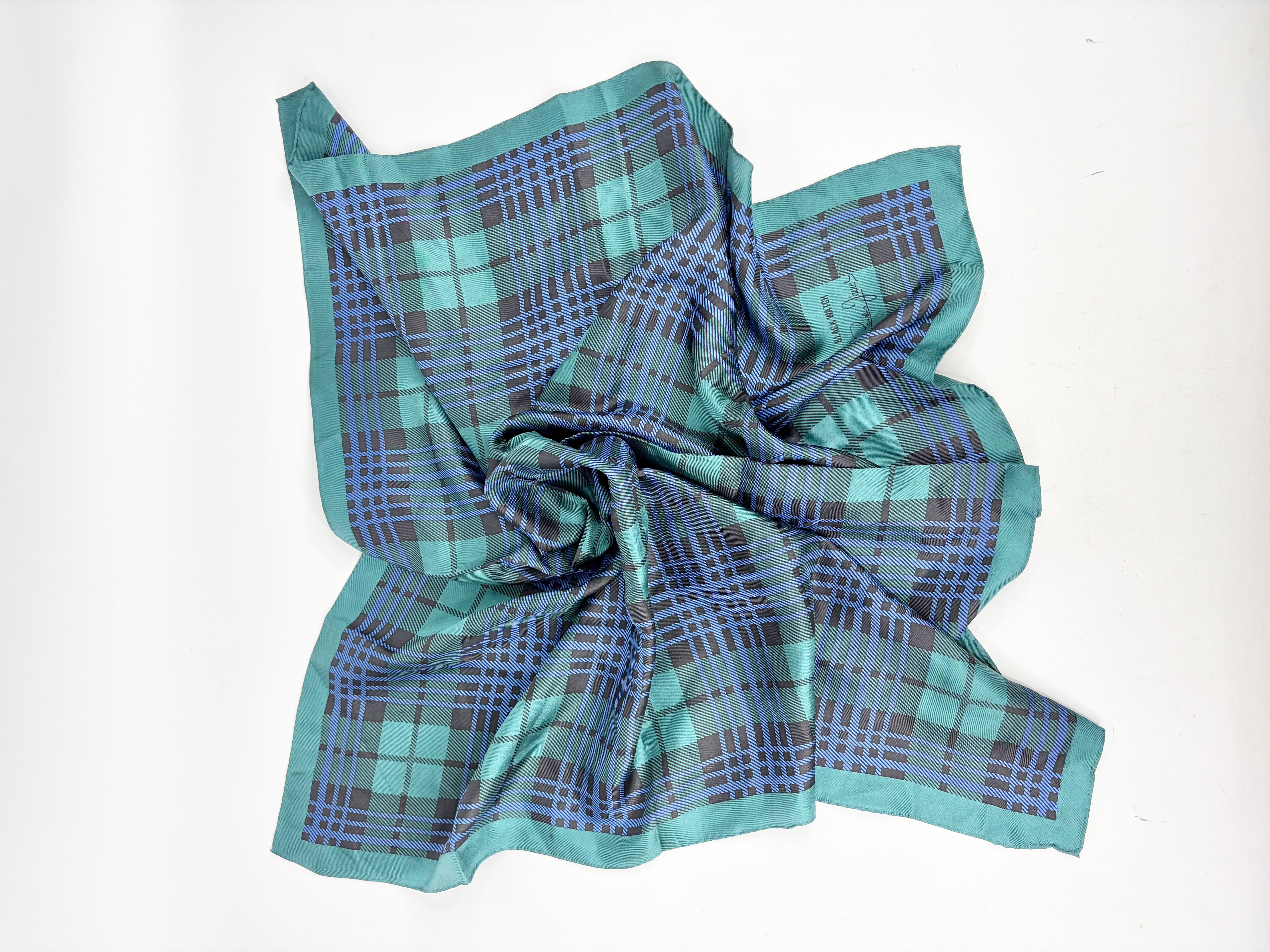 Plaid fabric in green and blue on a white background