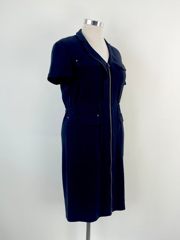Navy blue zip-up midi dress with short sleeves and pockets, displayed on a mannequin.