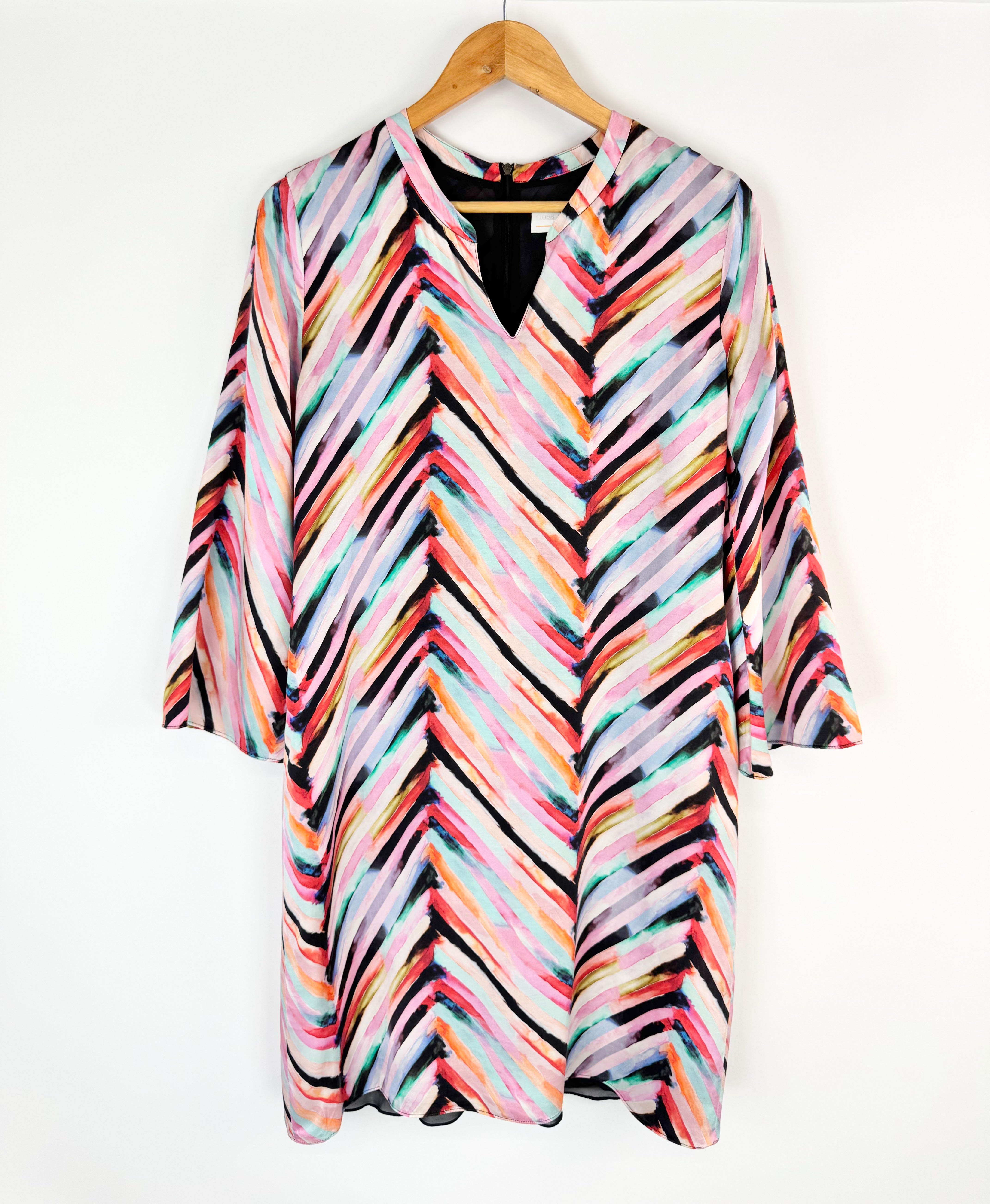 Colorful striped shirt on a hanger against a white background