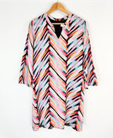 Colorful striped shirt on a hanger against a white background