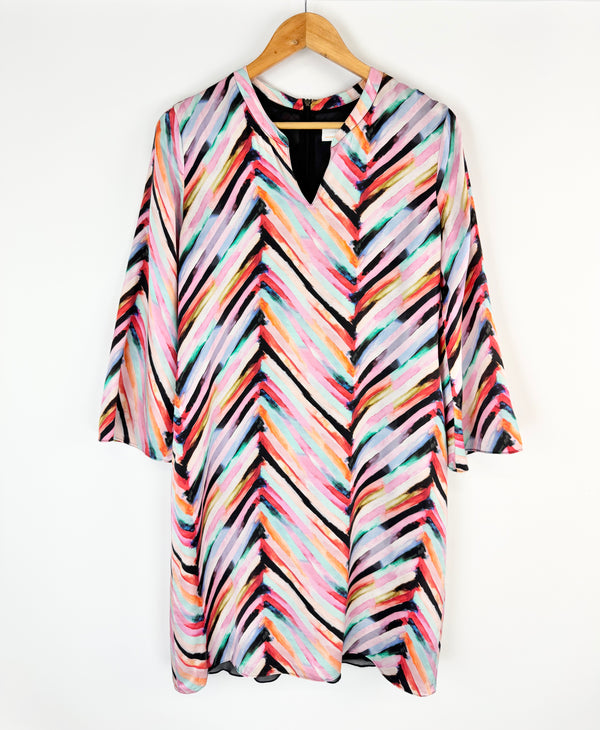 Colorful striped shirt on a hanger against a white background