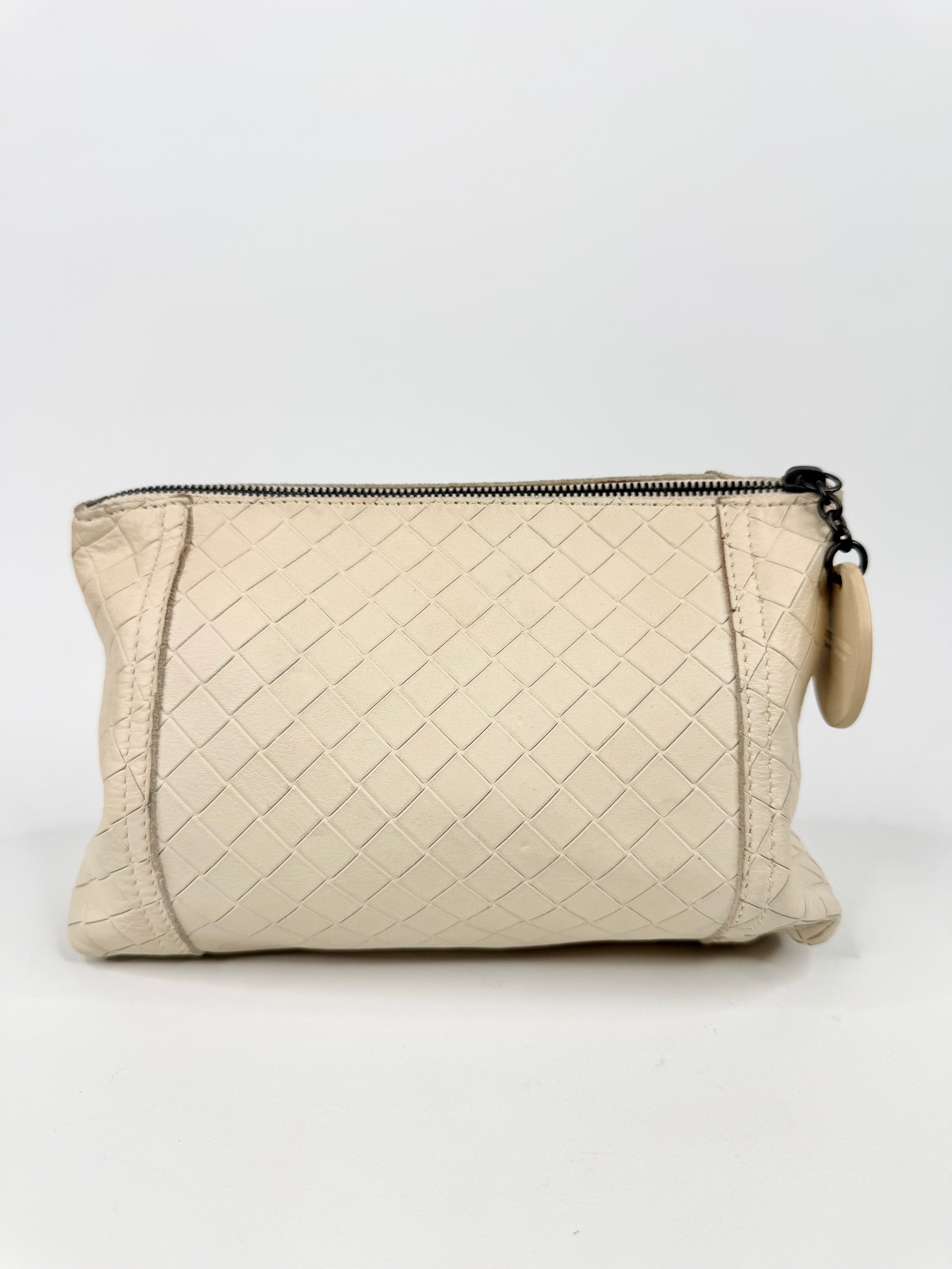 Beige quilted pouch with a zipper on a white background