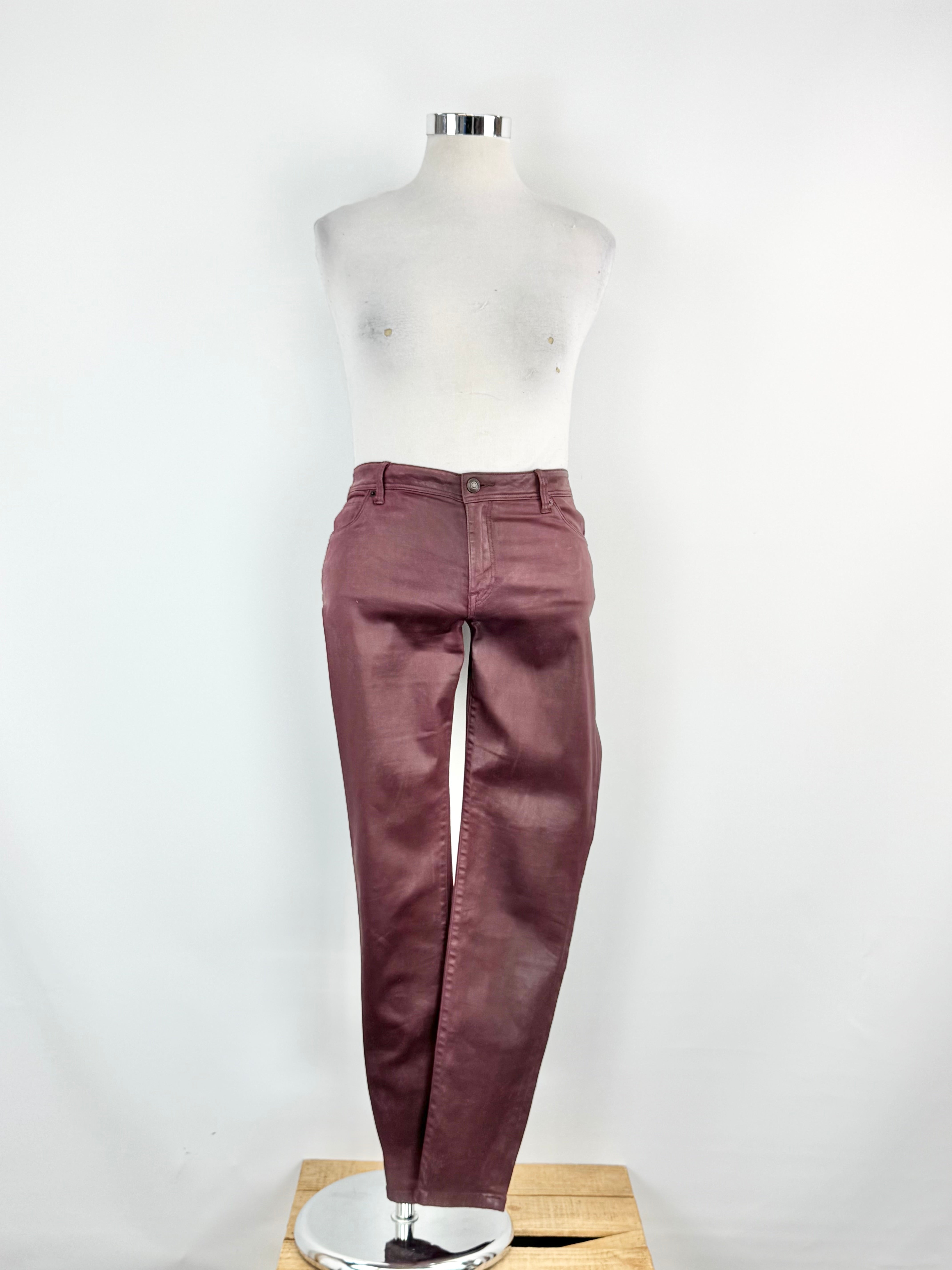 Purple jeans on a mannequin against a white background