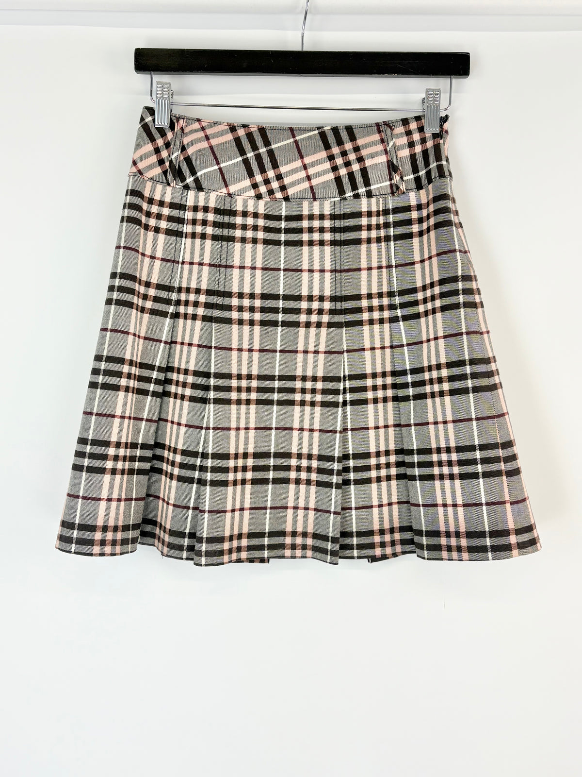 Plaid Burberry skirt on a hanger against a white background