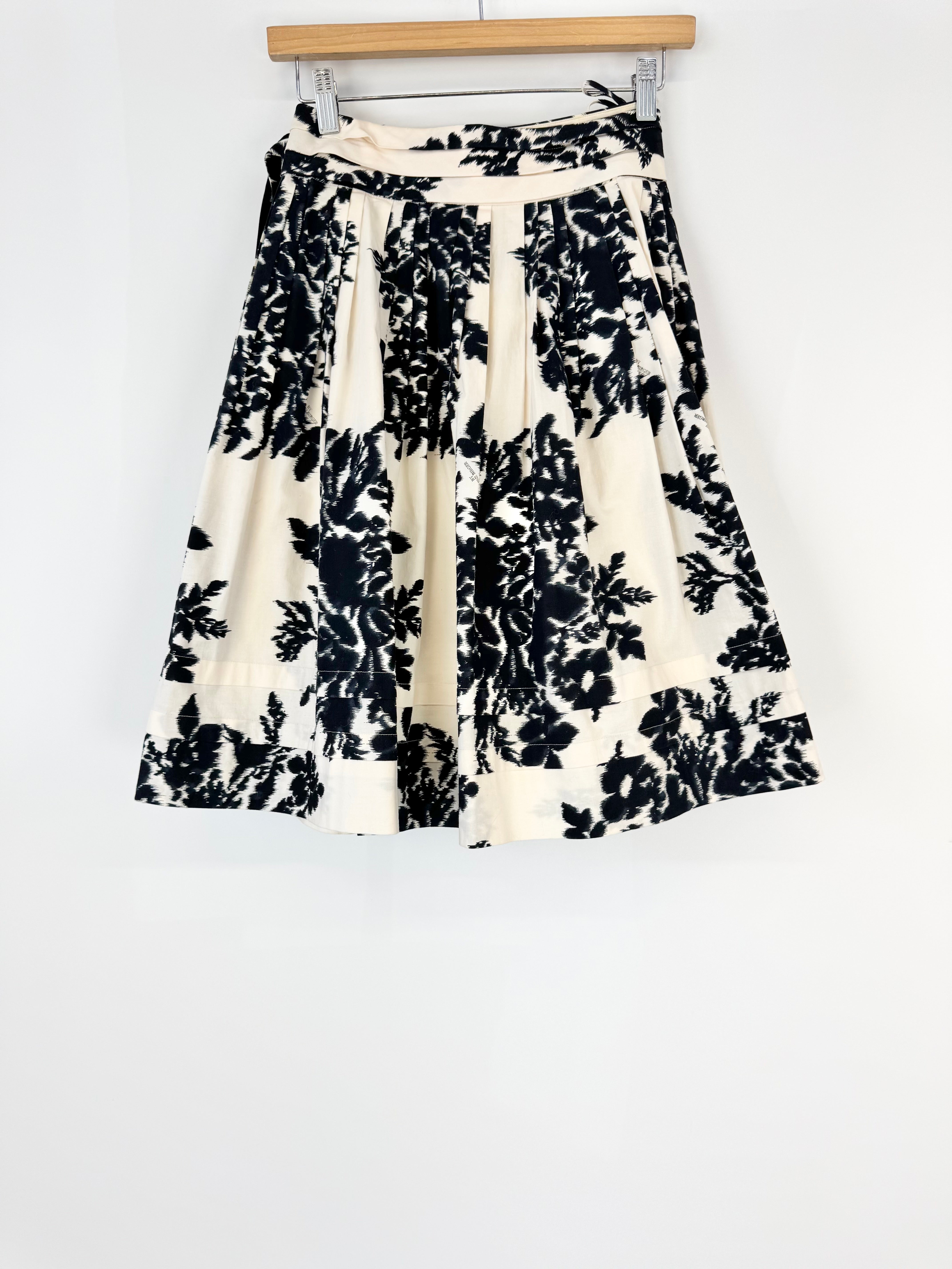 Black floral patterned skirt on a white background
