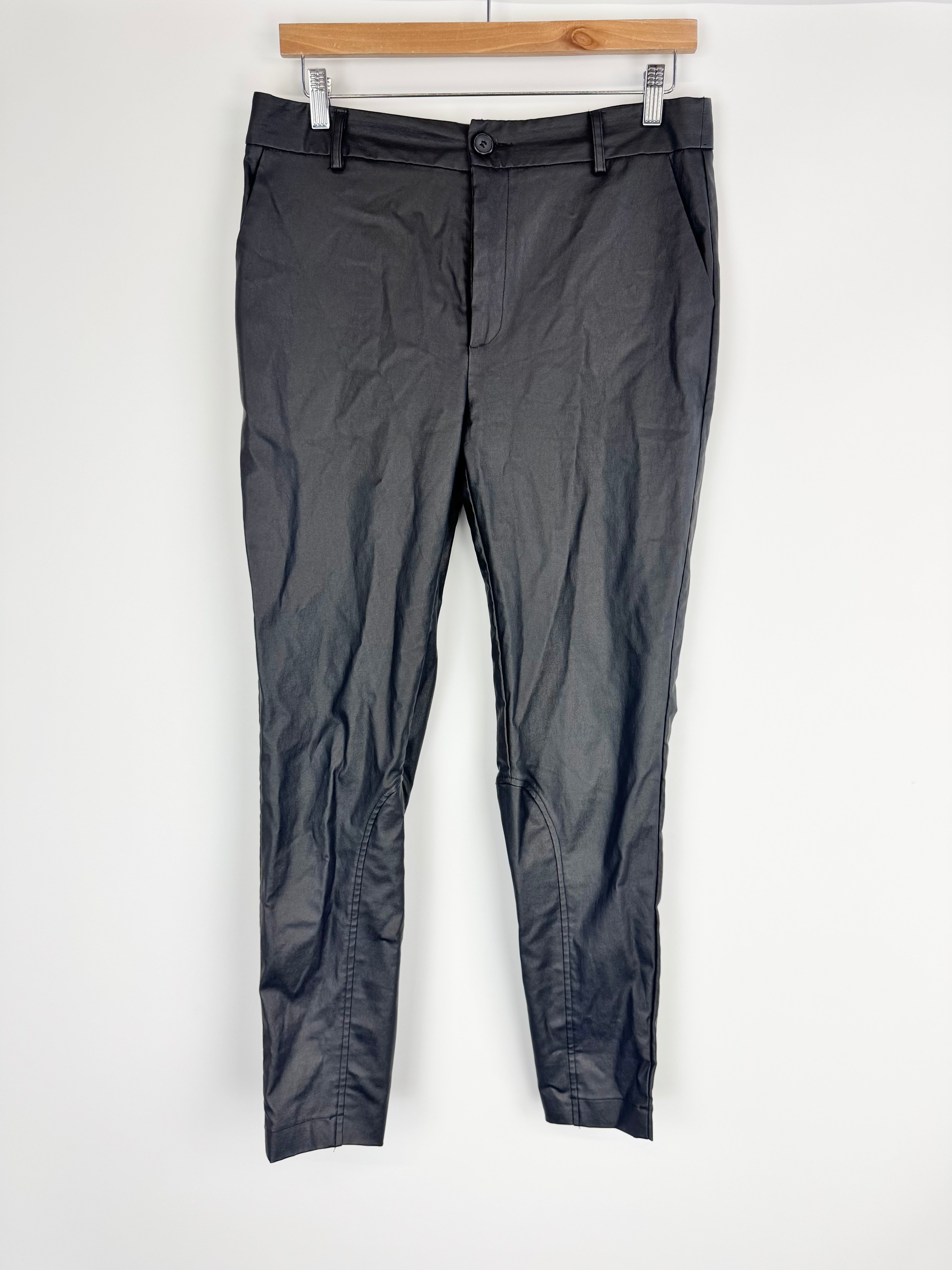 Dark gray pants on a hanger against a white background