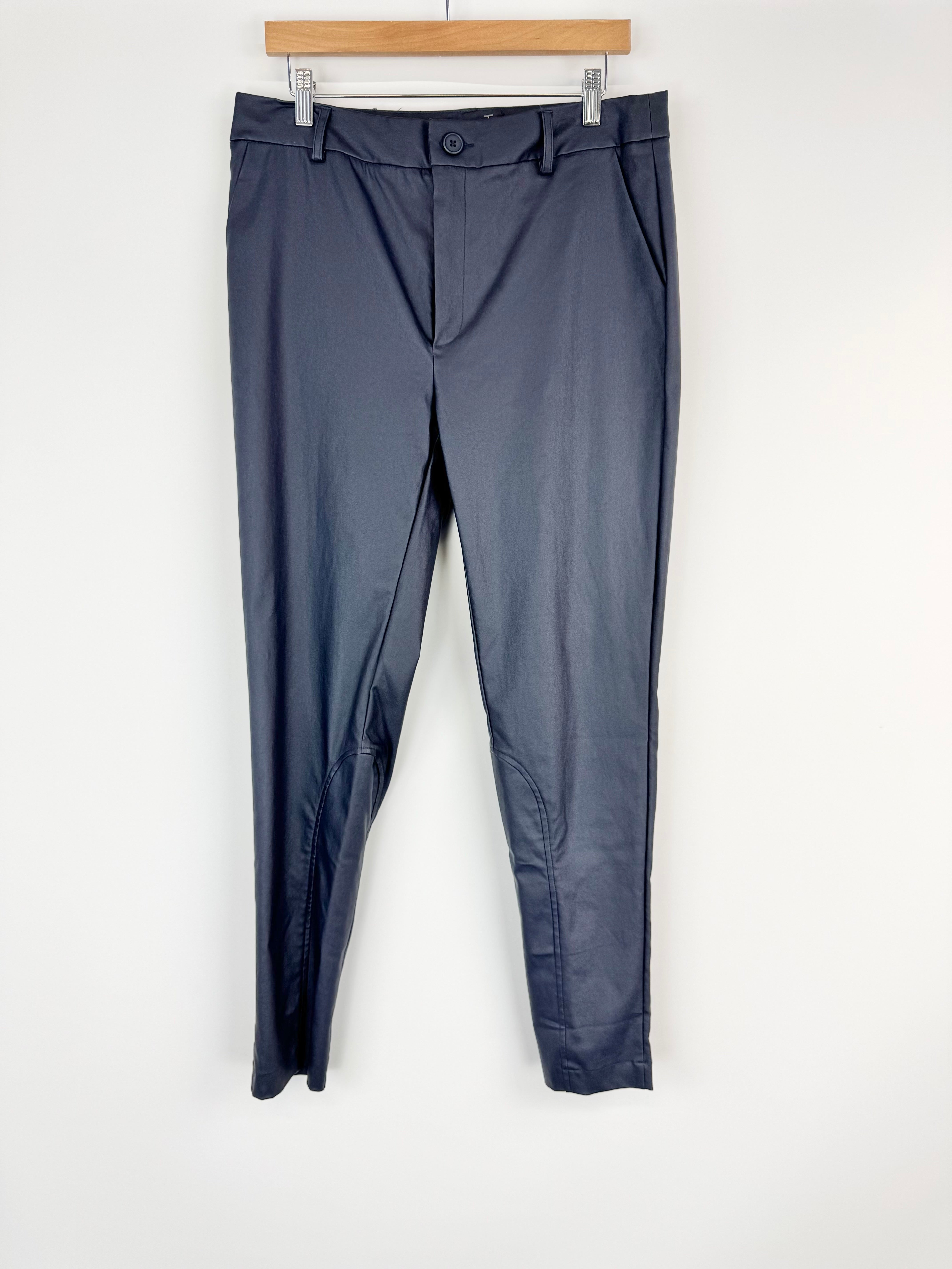 Dark gray pants hanging on a wooden hanger against a white background