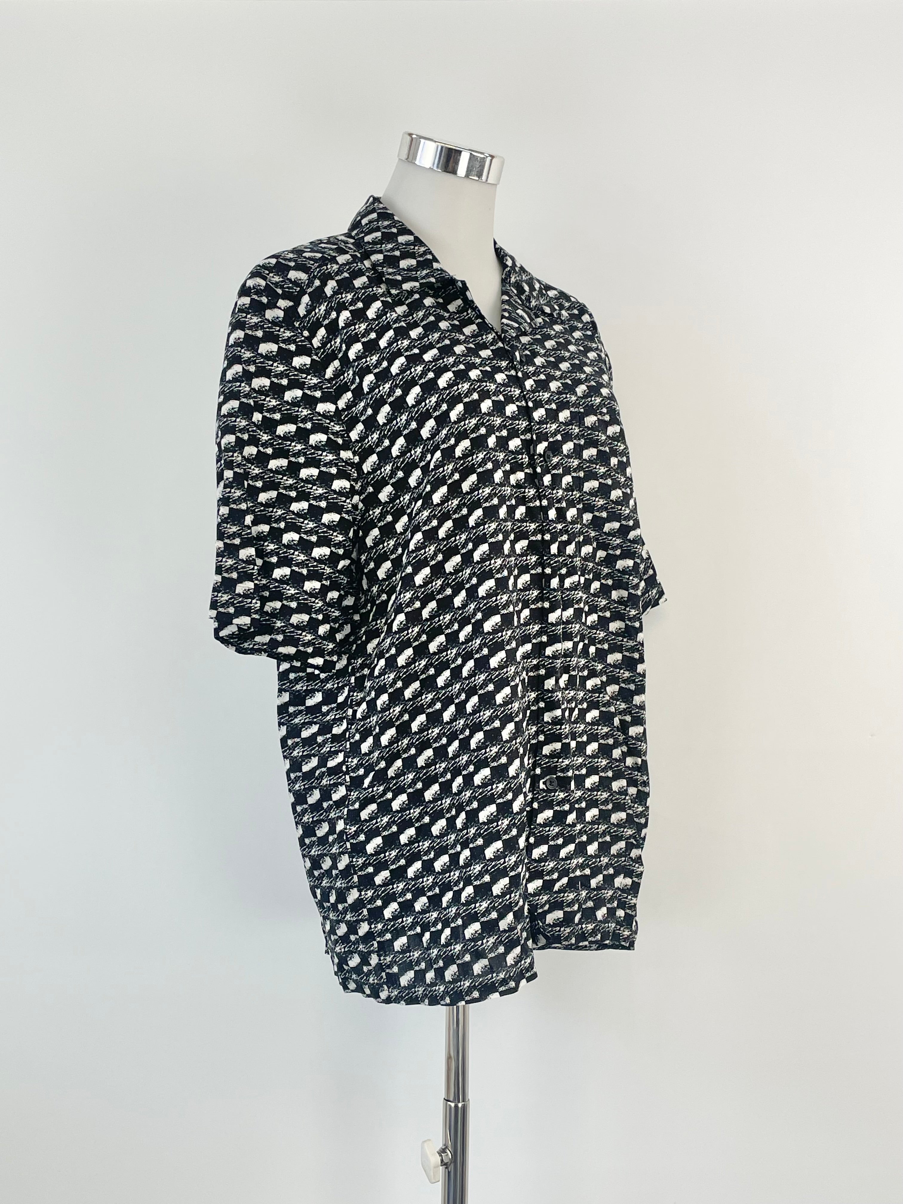 Short sleeve black and white striped shirt displayed on a mannequin.