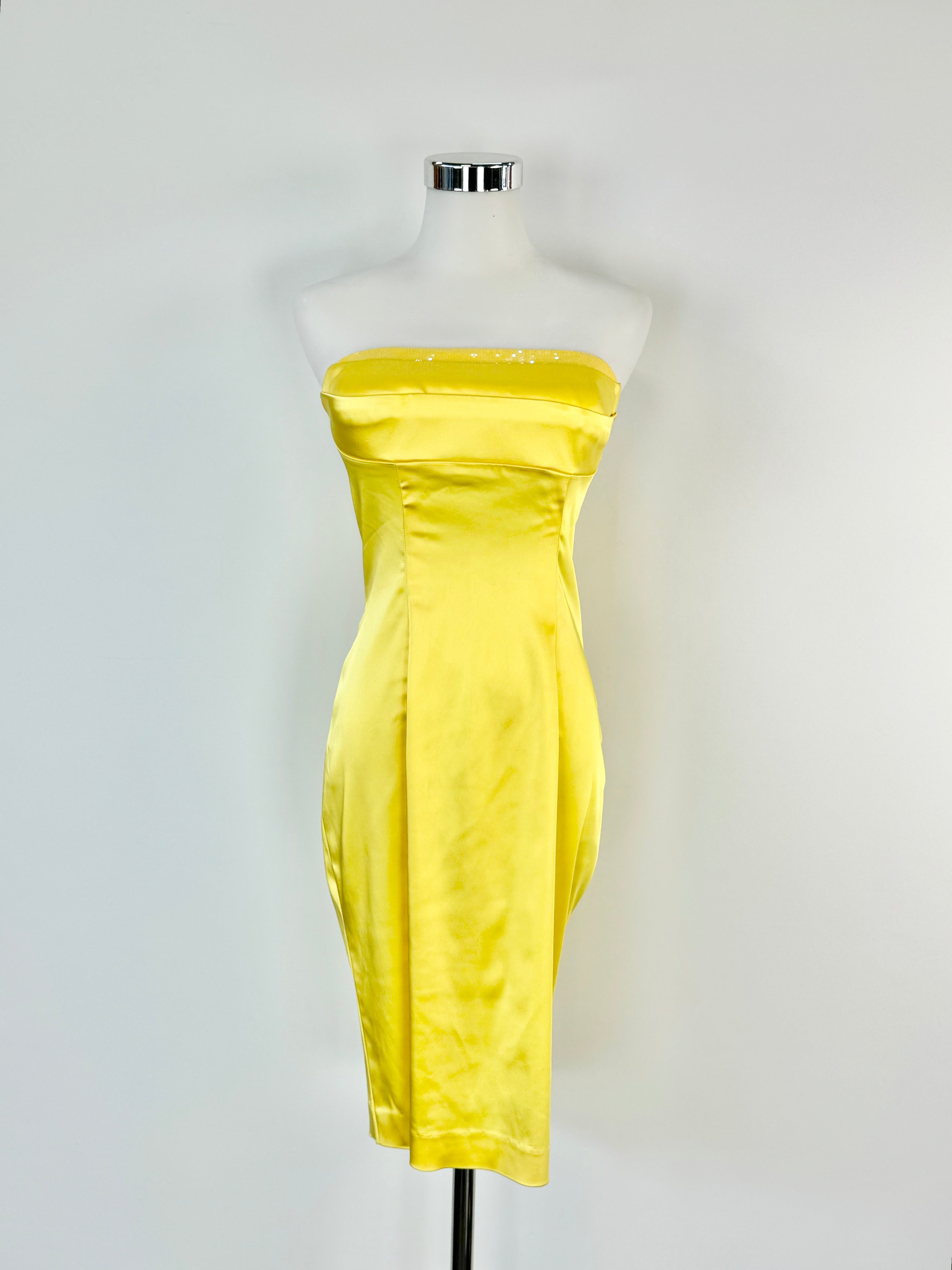 A yellow strapless midi dress displayed on a mannequin against a white background.