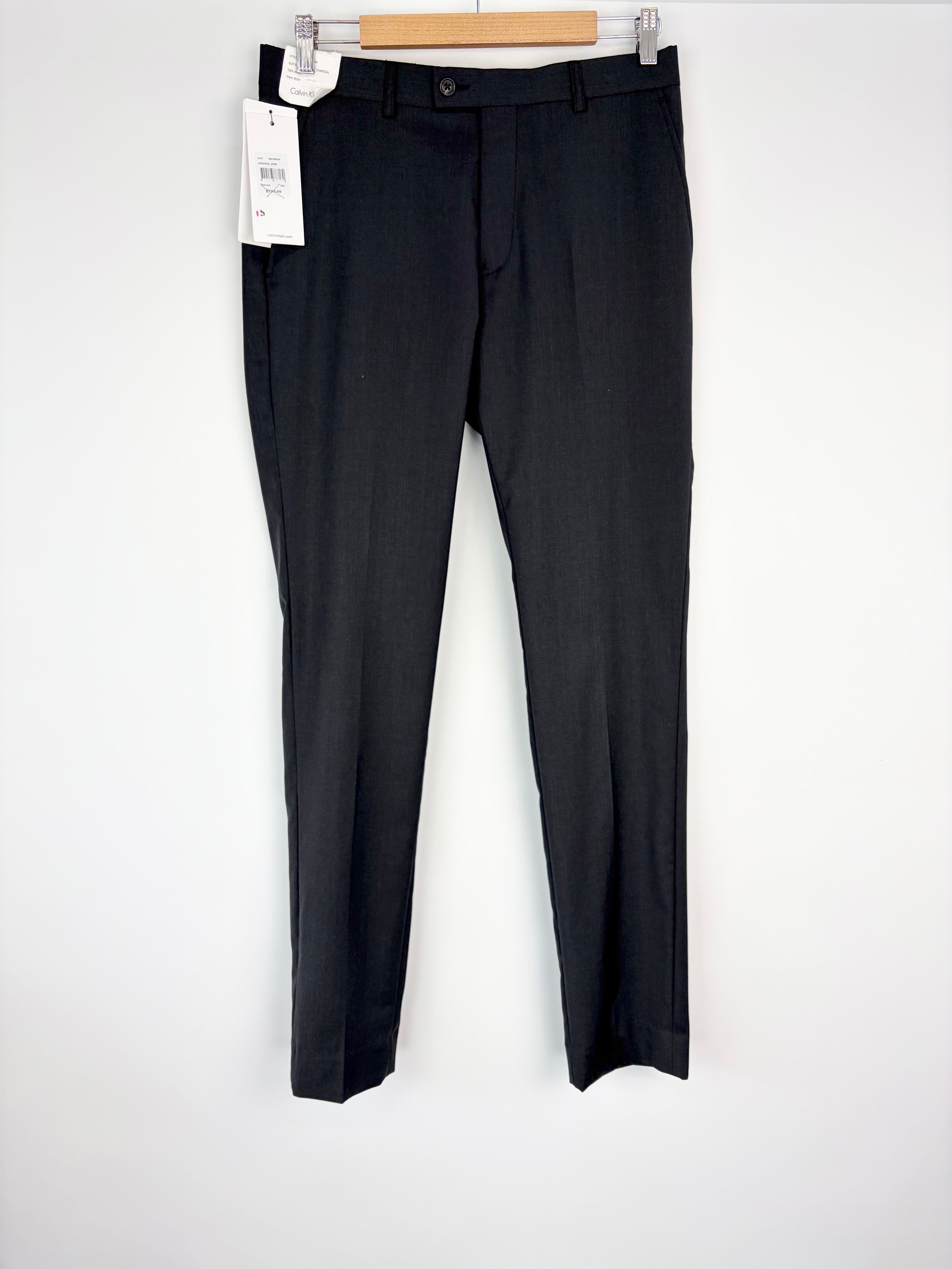 Black dress pants on a hanger with a white background