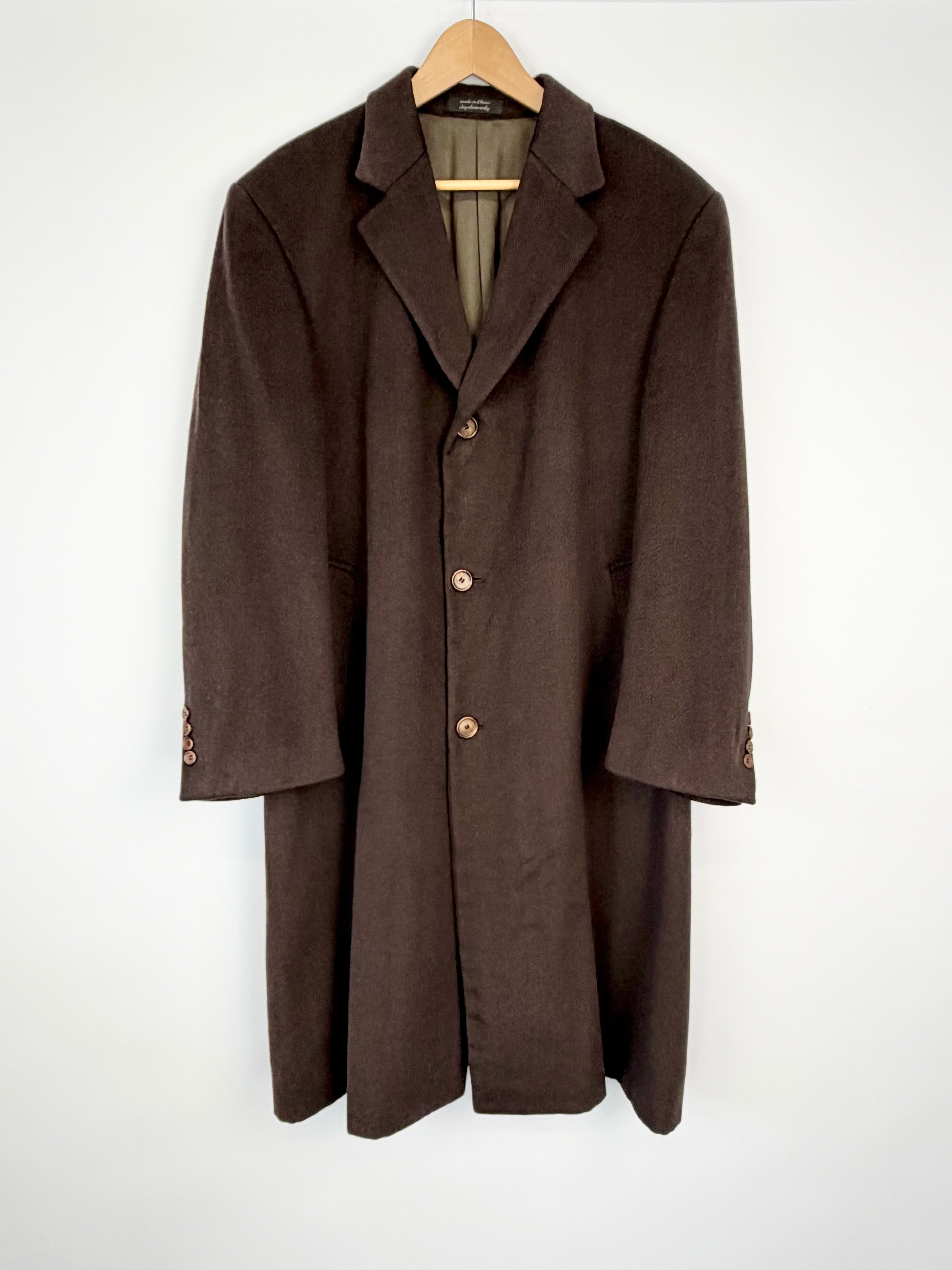 Brown coat on a hanger against a white background