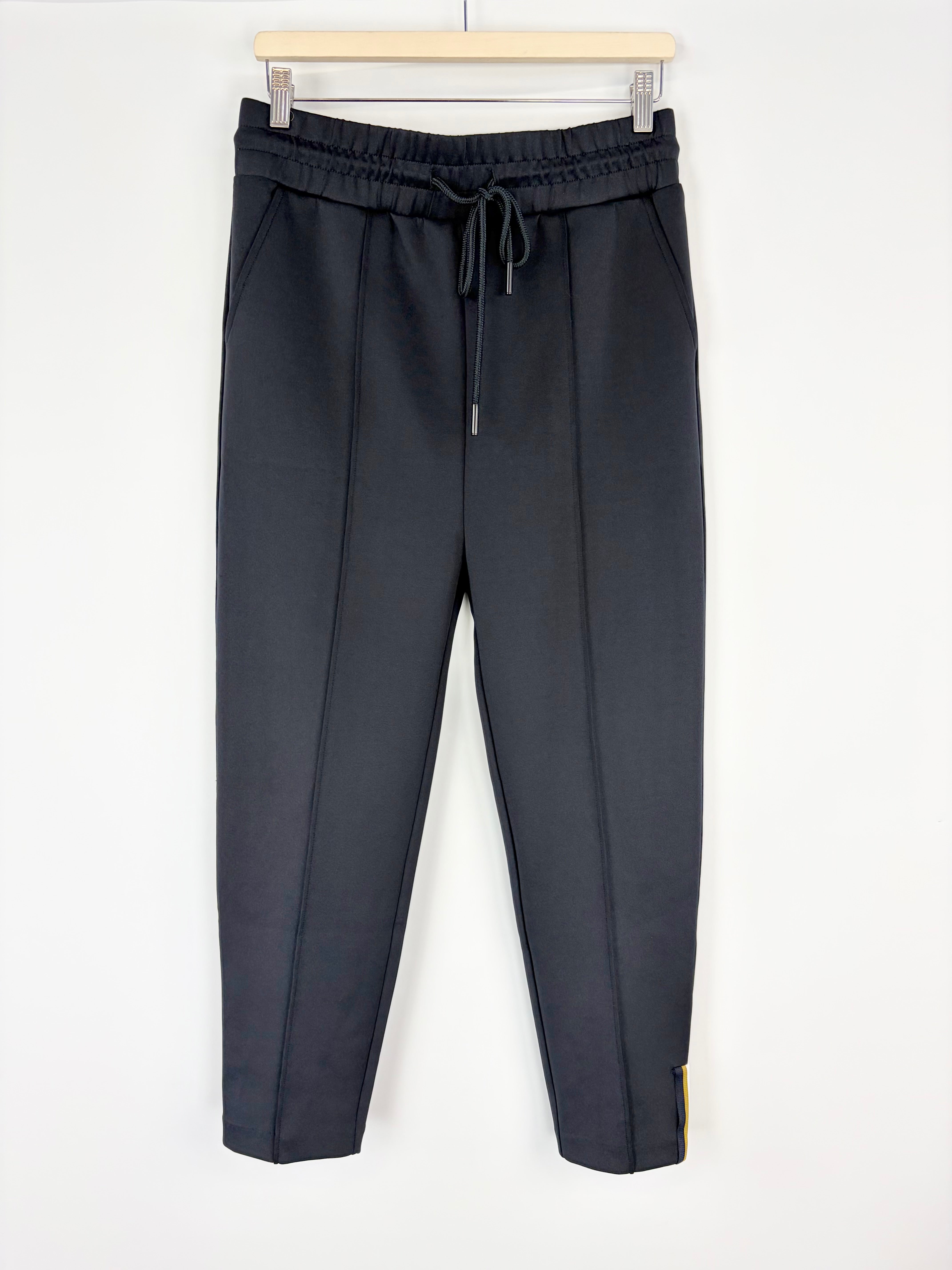 Black pants with drawstring waist on a white background