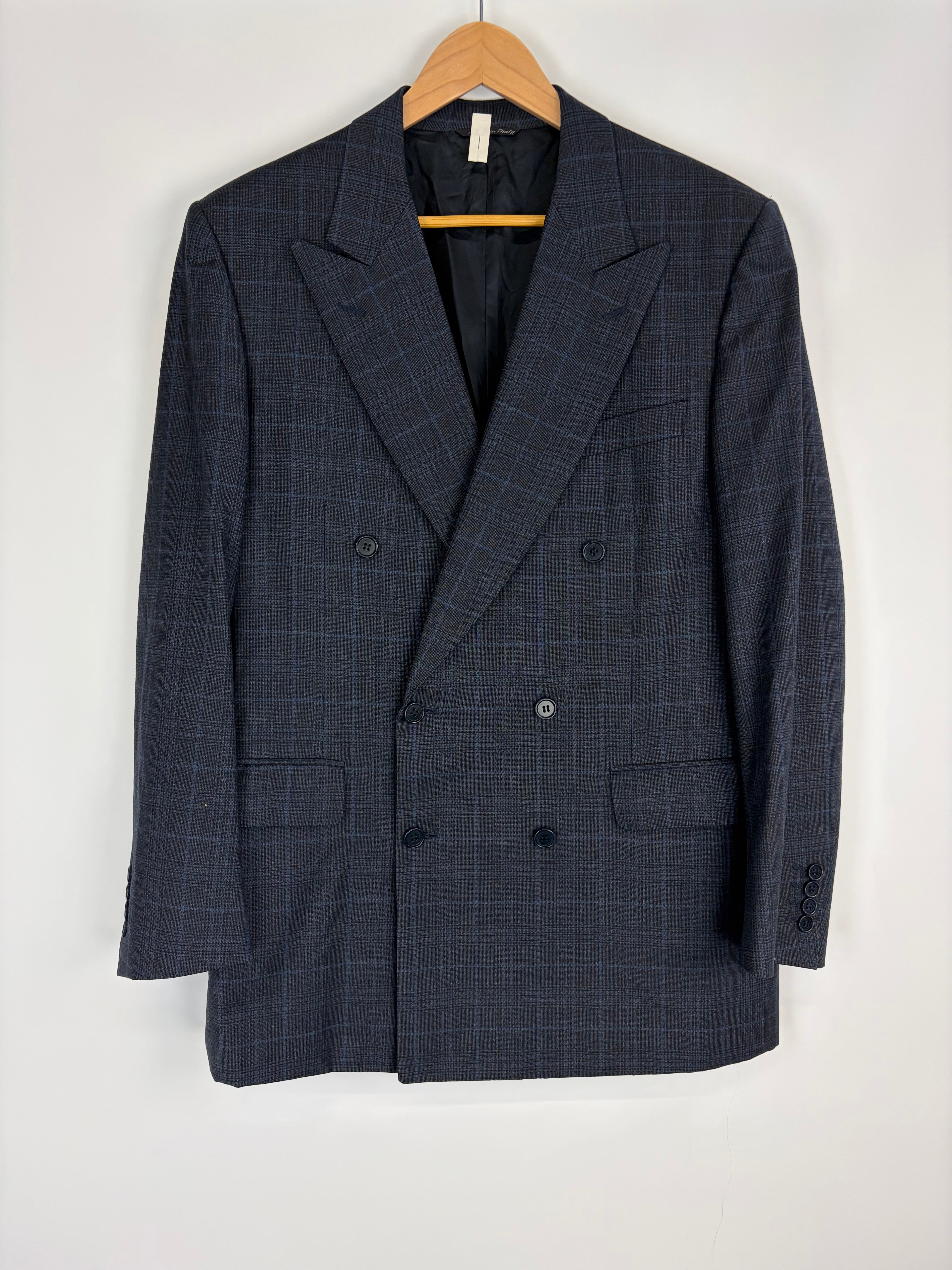 Blue checkered blazer on a hanger against a white background
