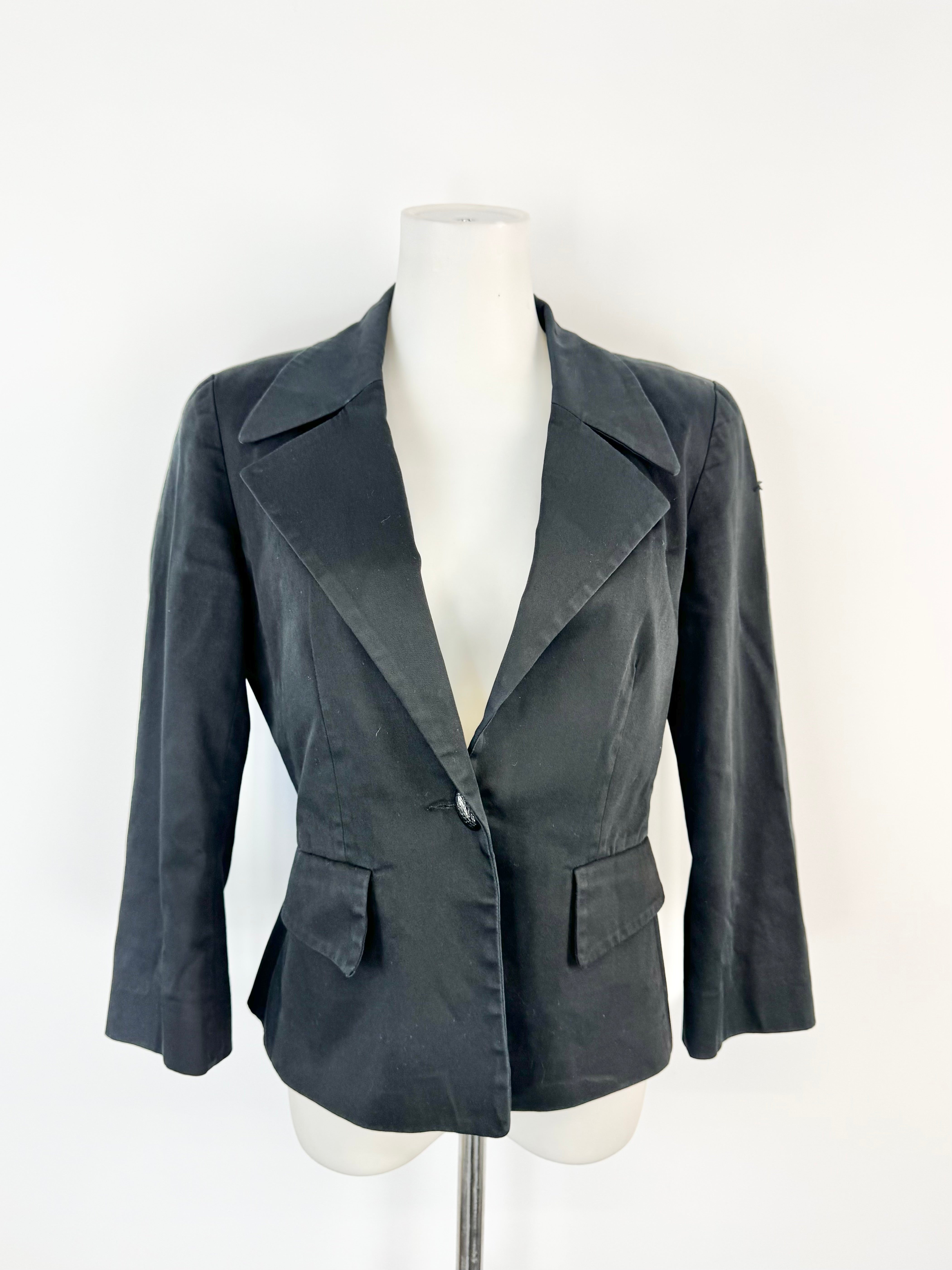 Black blazer on a mannequin against a white background