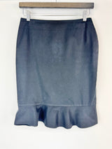 Blue skirt on a hanger against a white background