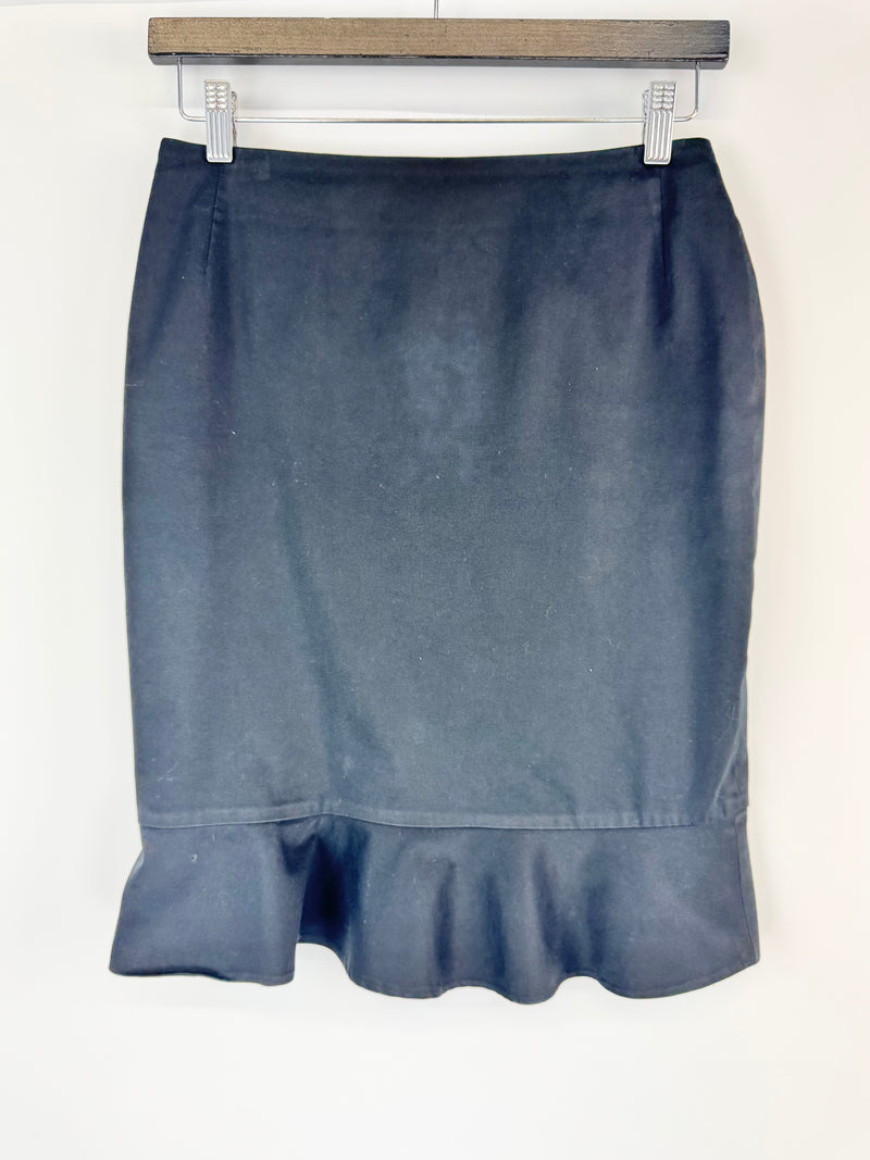 Blue skirt on a hanger against a white background