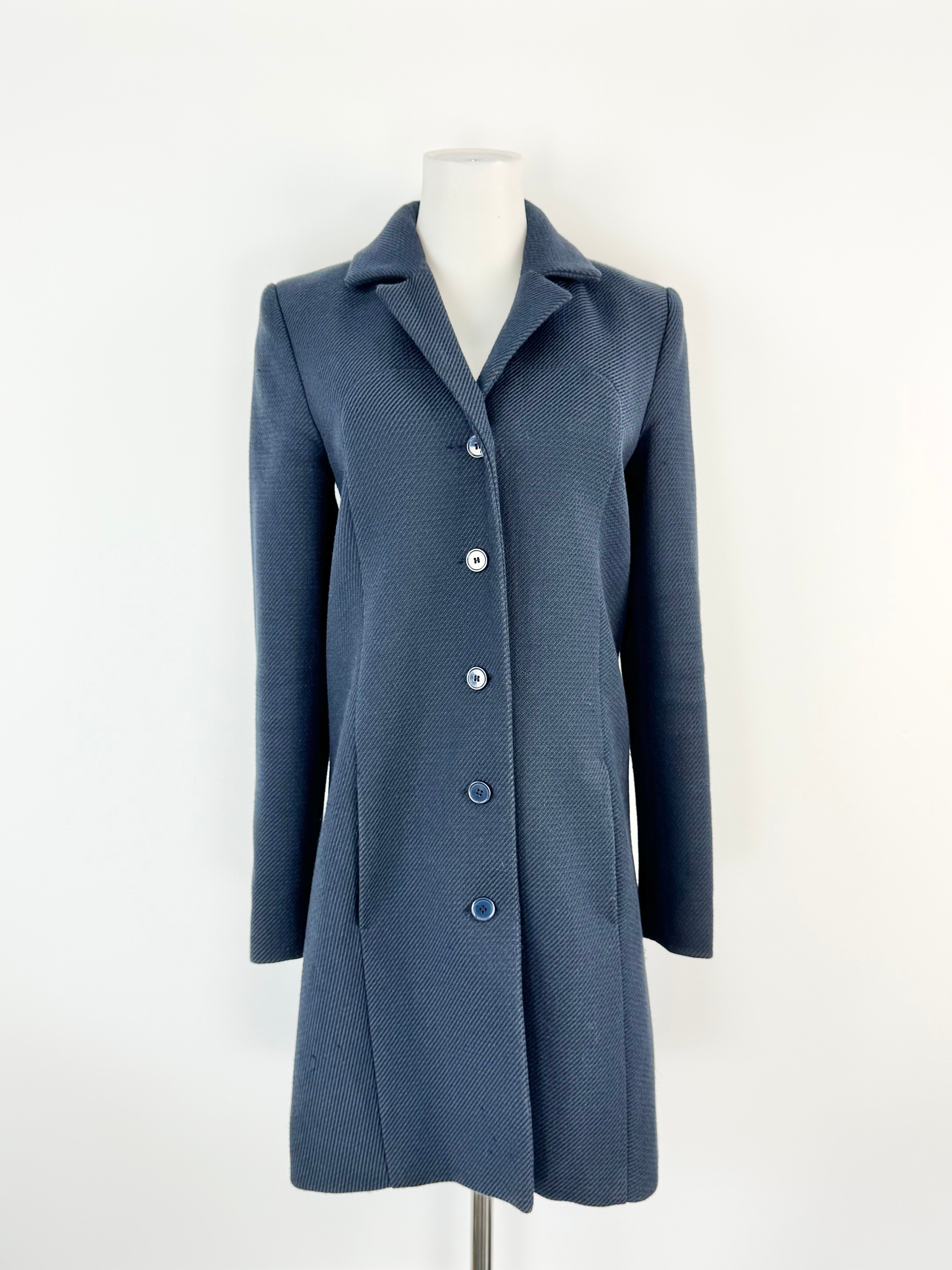 Blue coat on a mannequin against a white background