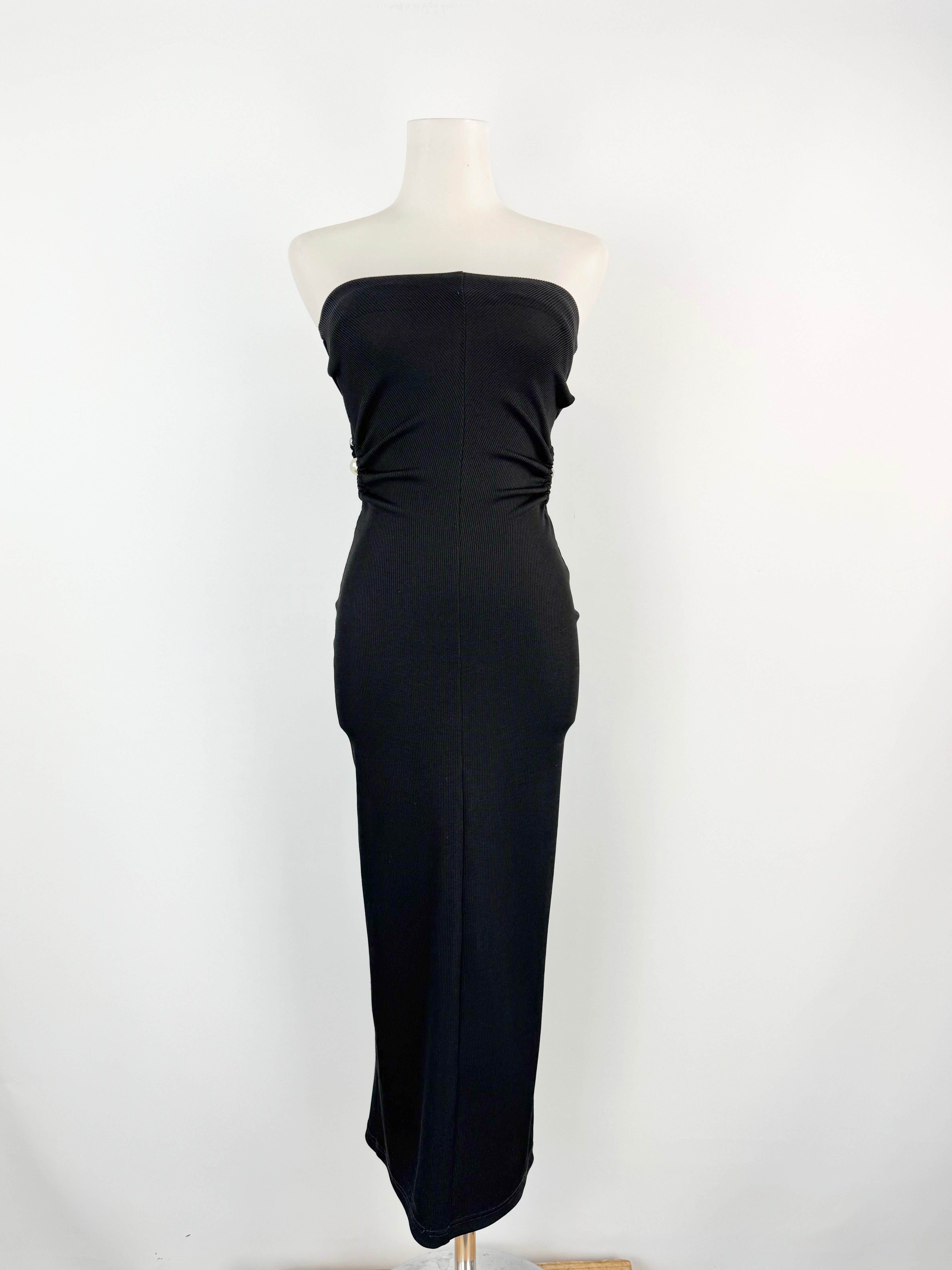 Black strapless gown on a mannequin against a white background