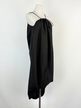 Black dress on a mannequin against a white background