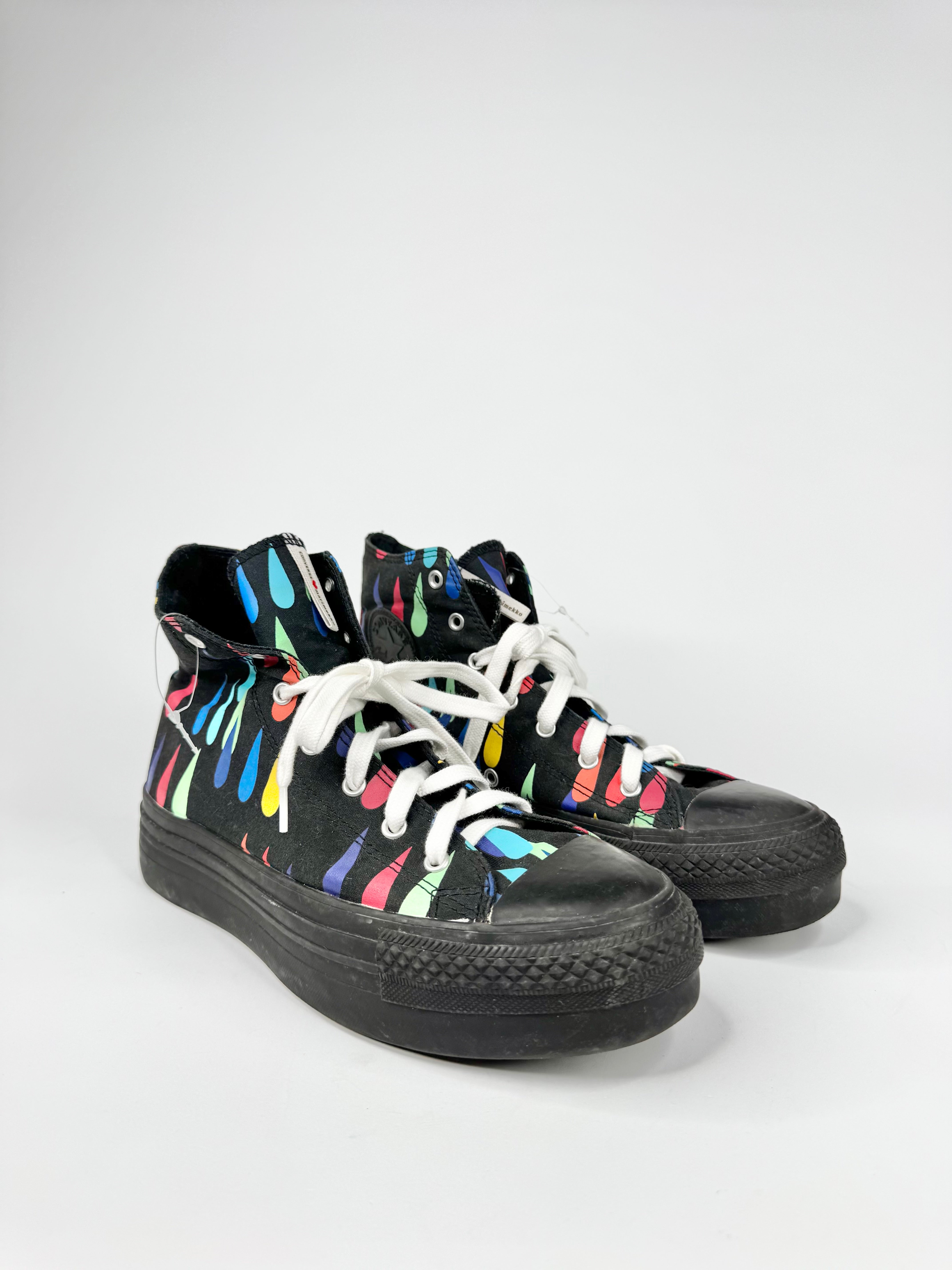 Black high-top sneakers with colorful designs on a white background