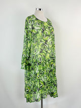 Green patterned dress on a mannequin against a white background