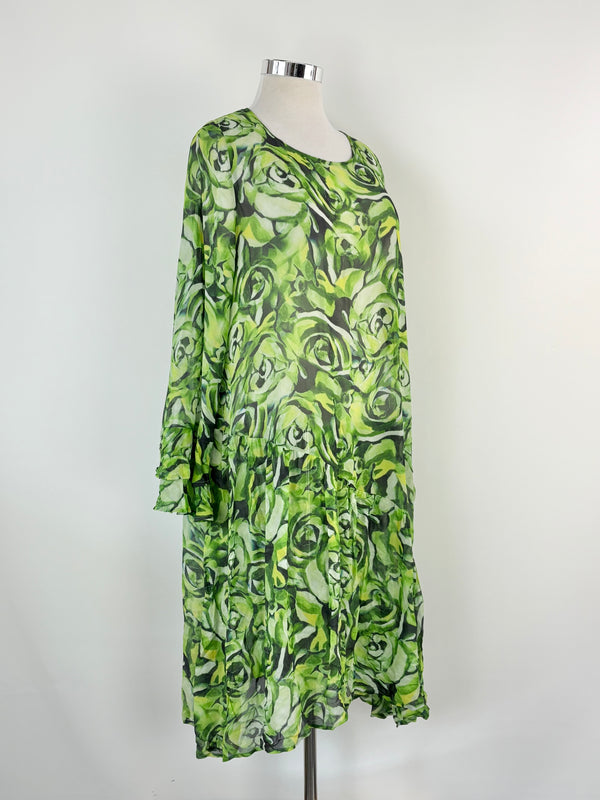 Green patterned dress on a mannequin against a white background