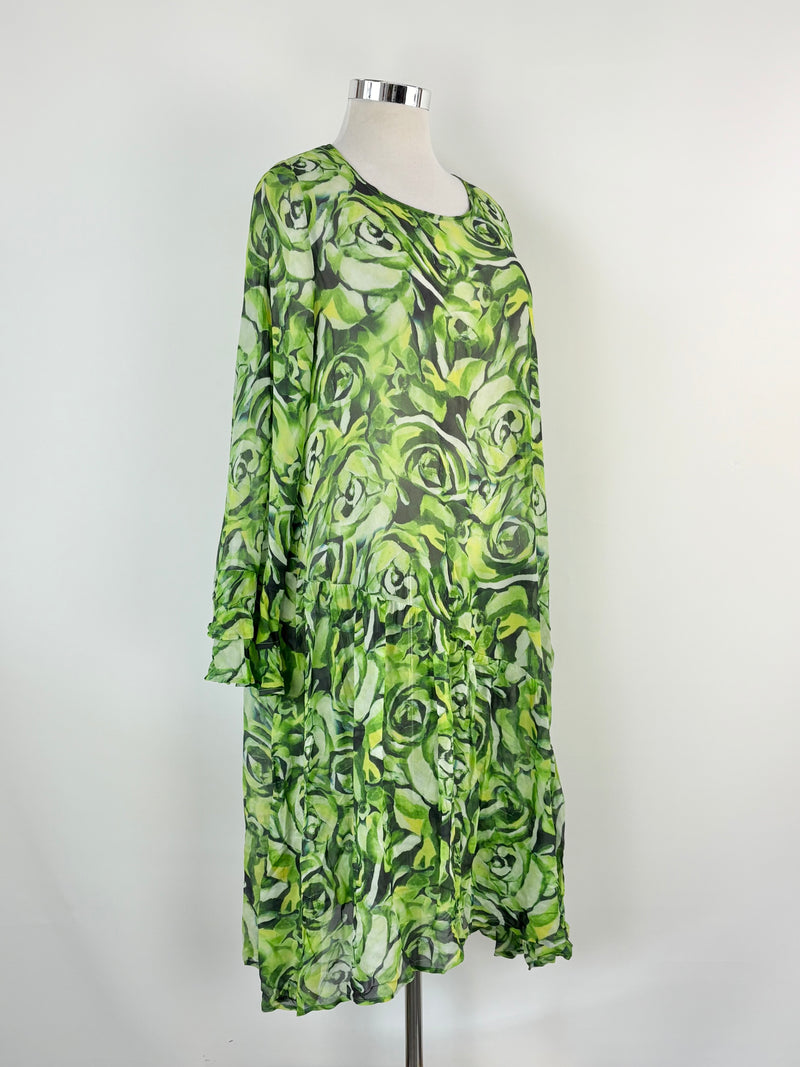 Green patterned dress on a mannequin against a white background
