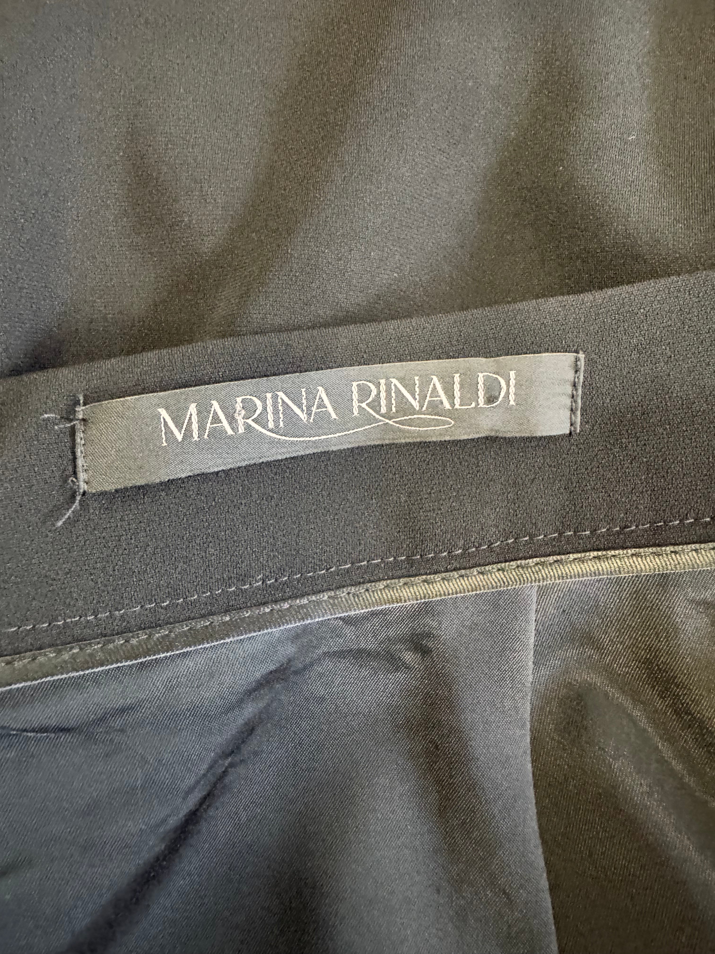 Close-up of a Marina Rinaldi label on a gray fabric background