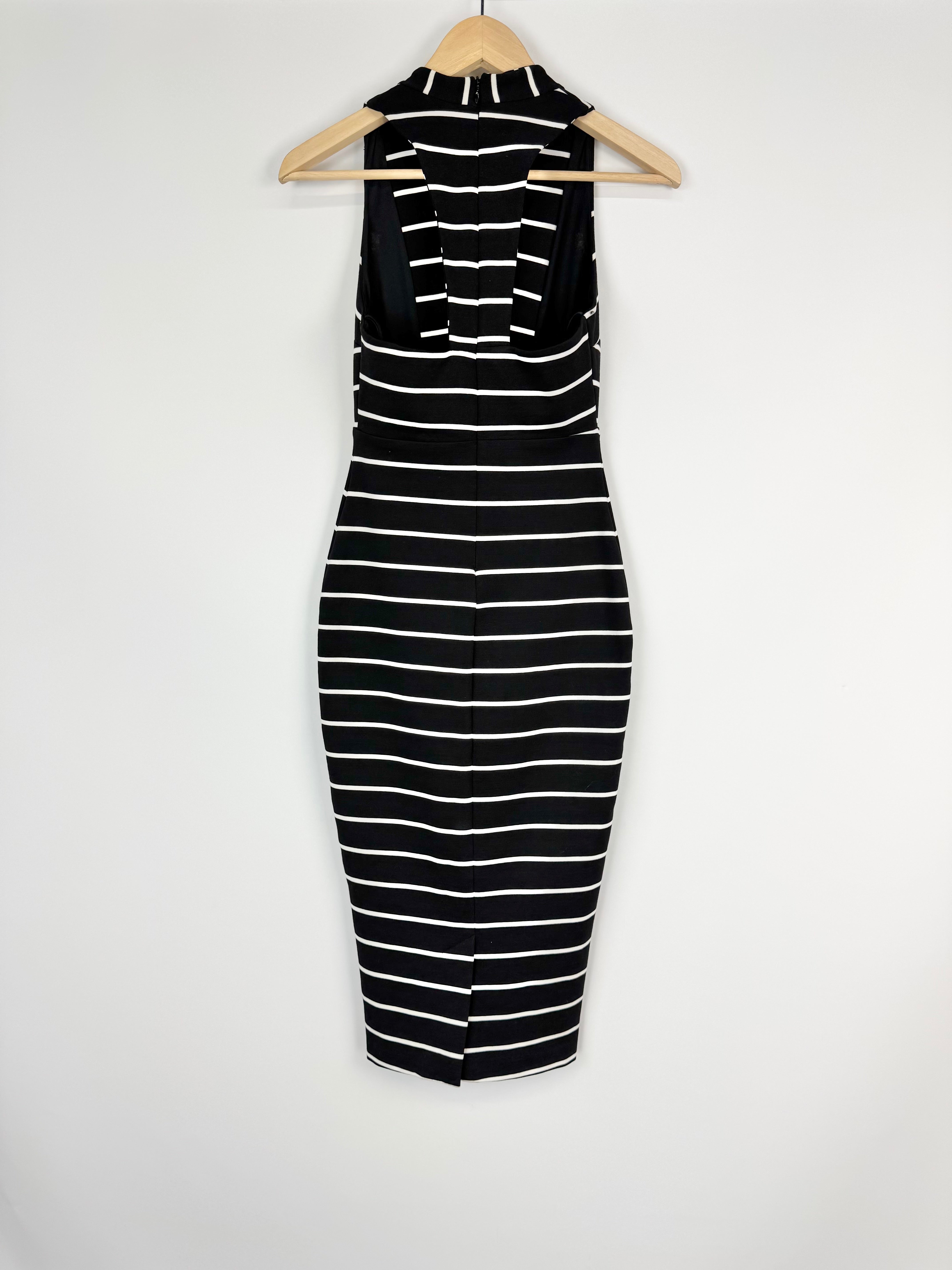 Black and white striped dress on a hanger against a white background