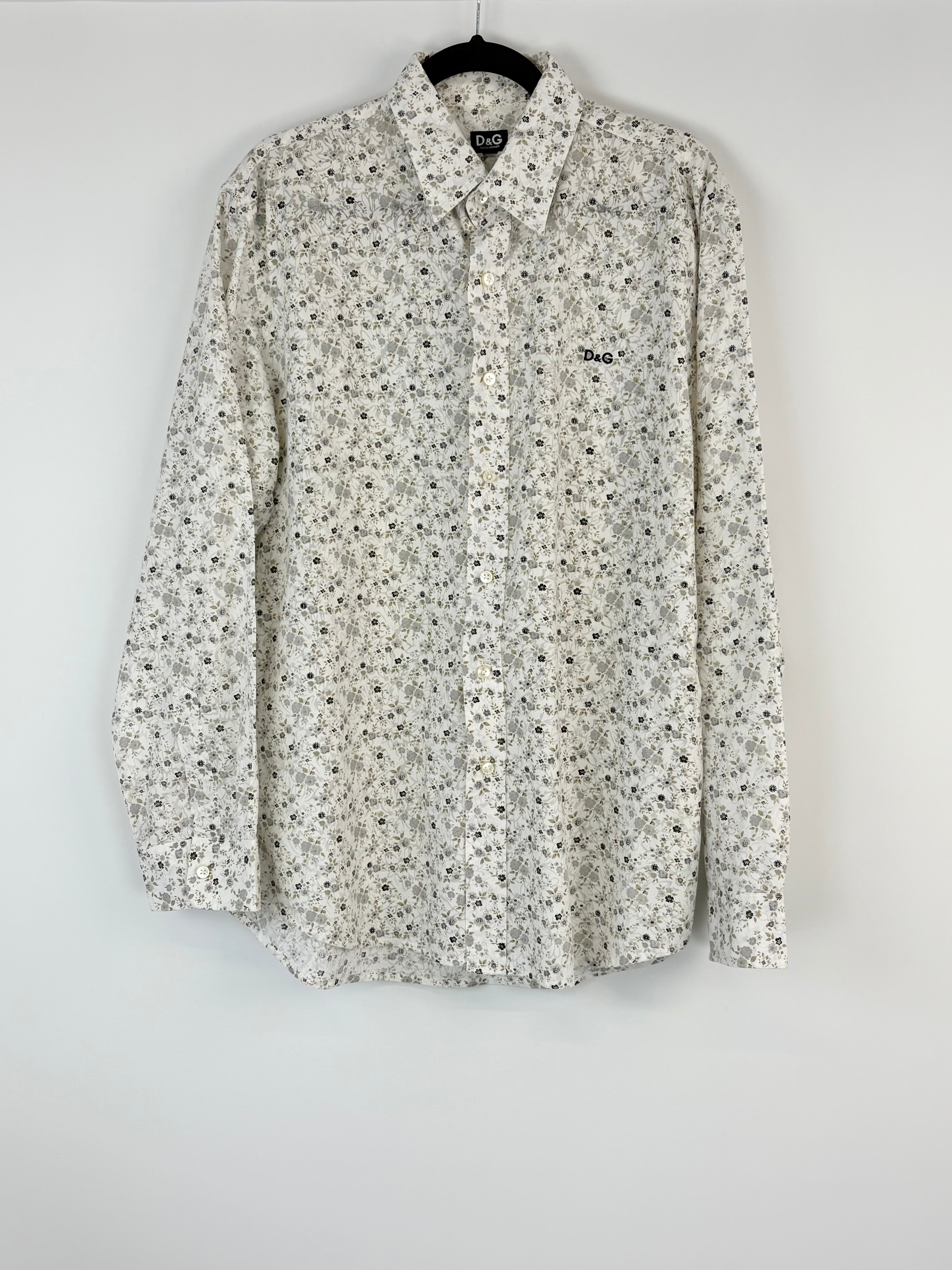 Floral patterned shirt on a hanger against a white background