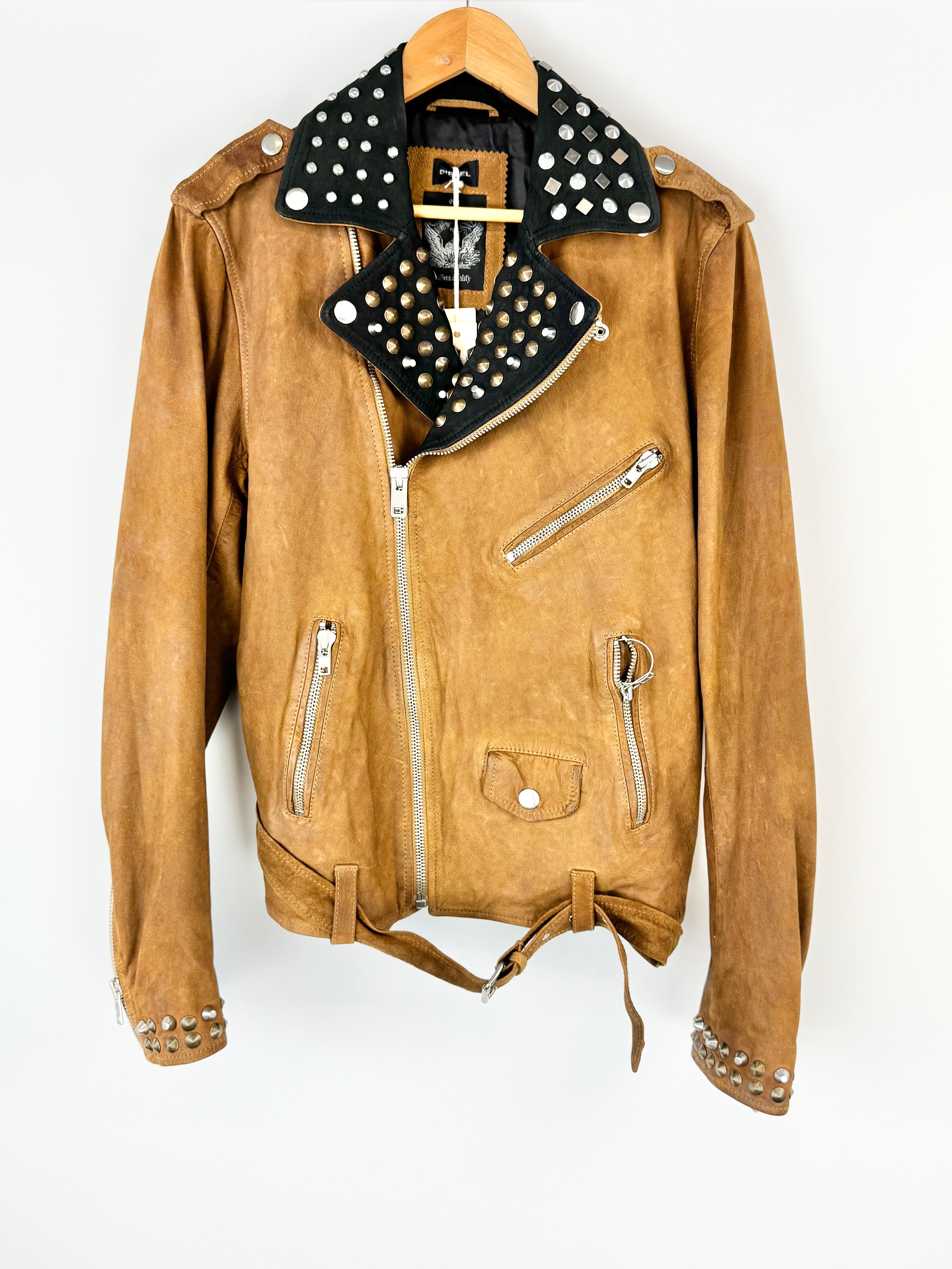 Brown leather jacket with studded details on a hanger against a white background