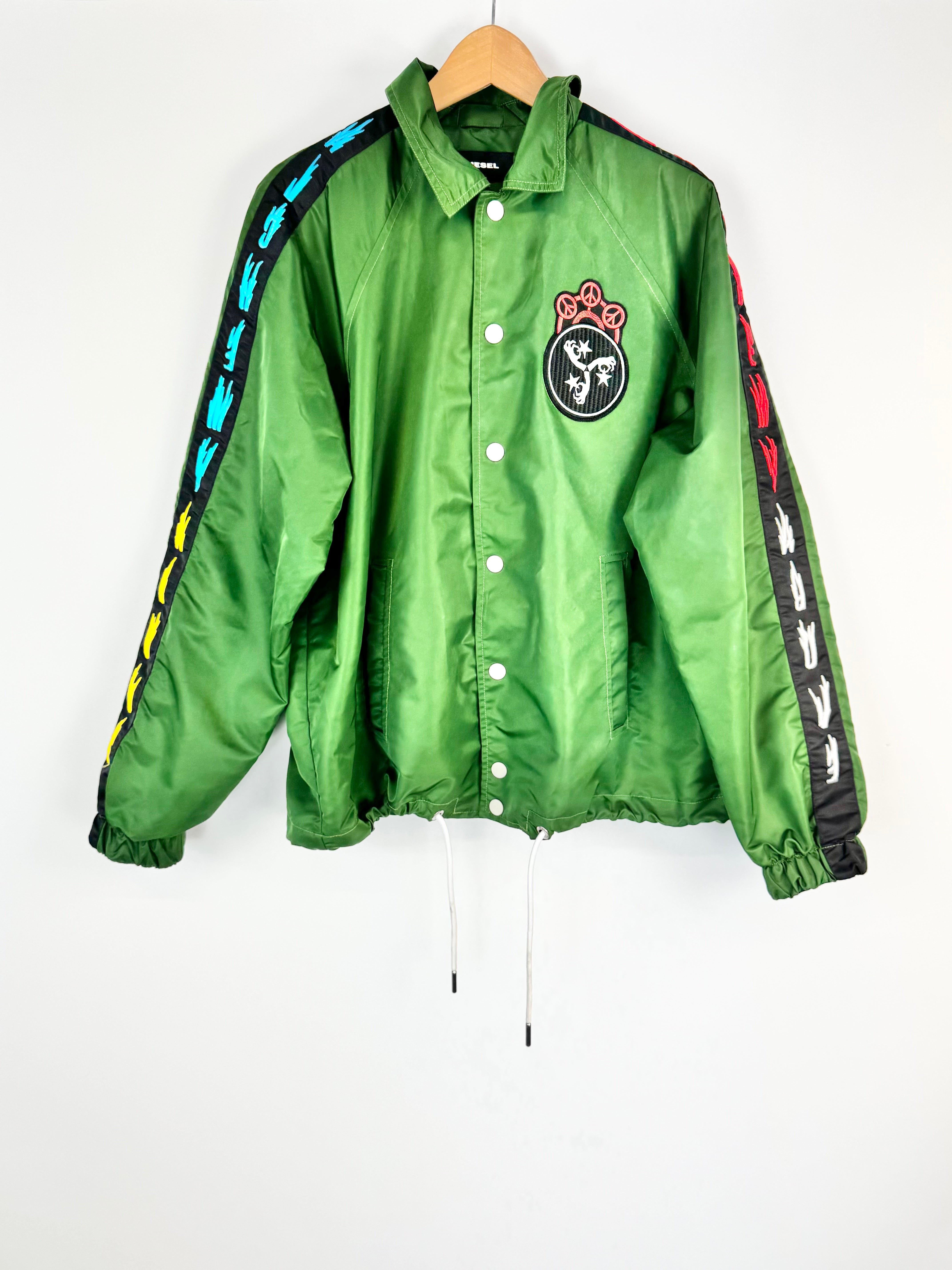 Green jacket with colorful side panels on a hanger against a white background