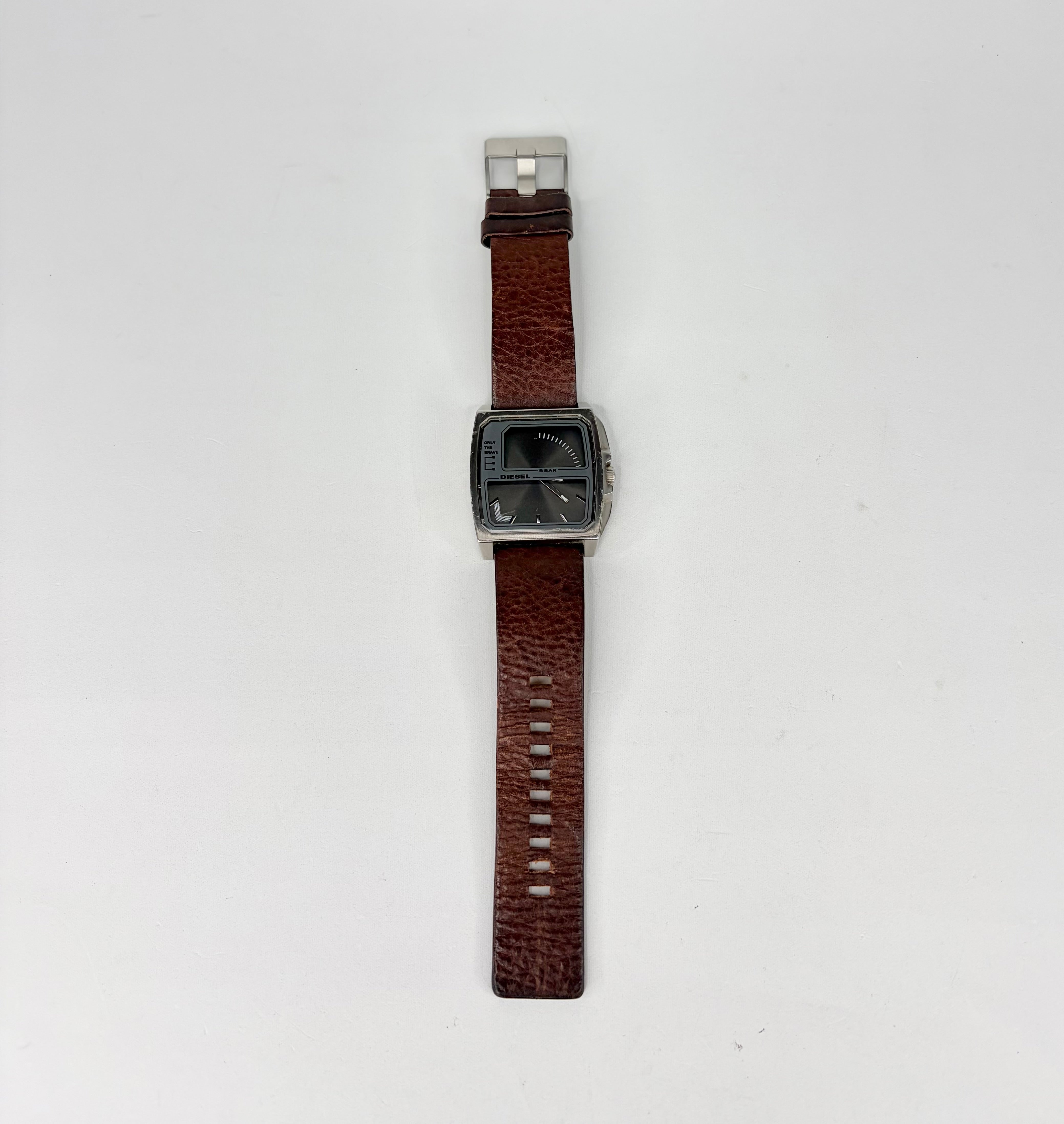 Watch with a brown strap and silver case on a white background