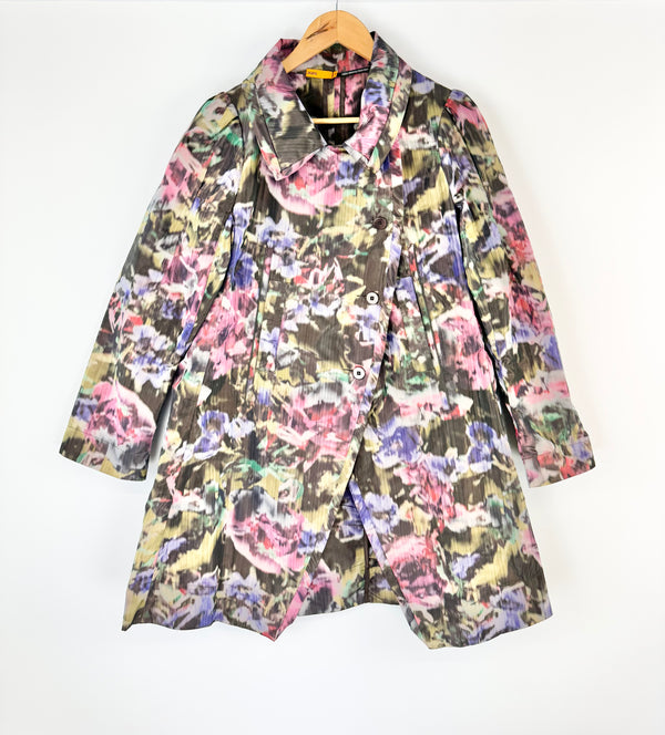 Floral patterned coat on a hanger against a white background