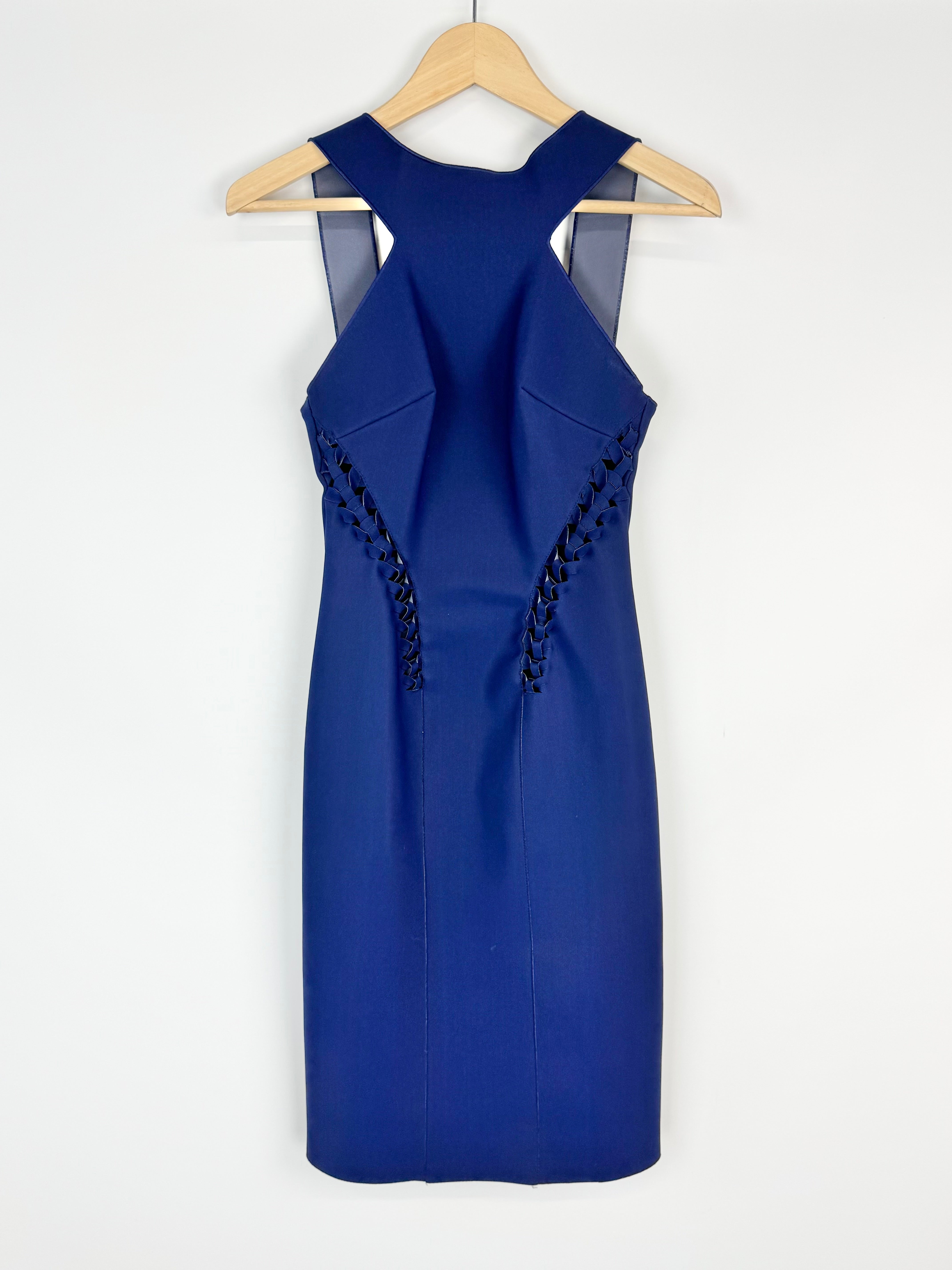 Blue dress with cut-out shoulders on a hanger against a white background