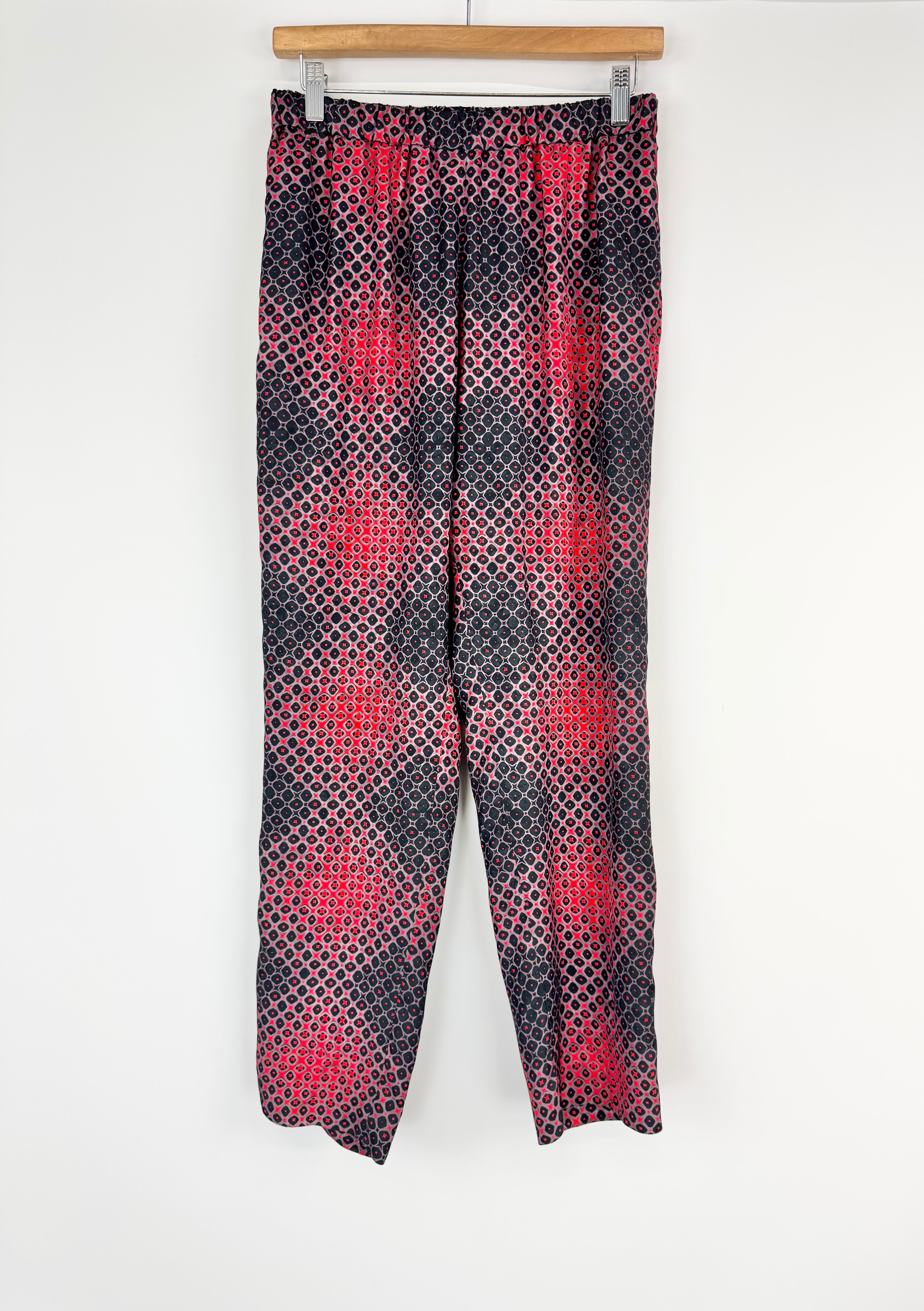 Patterned pants on a hanger against a white background