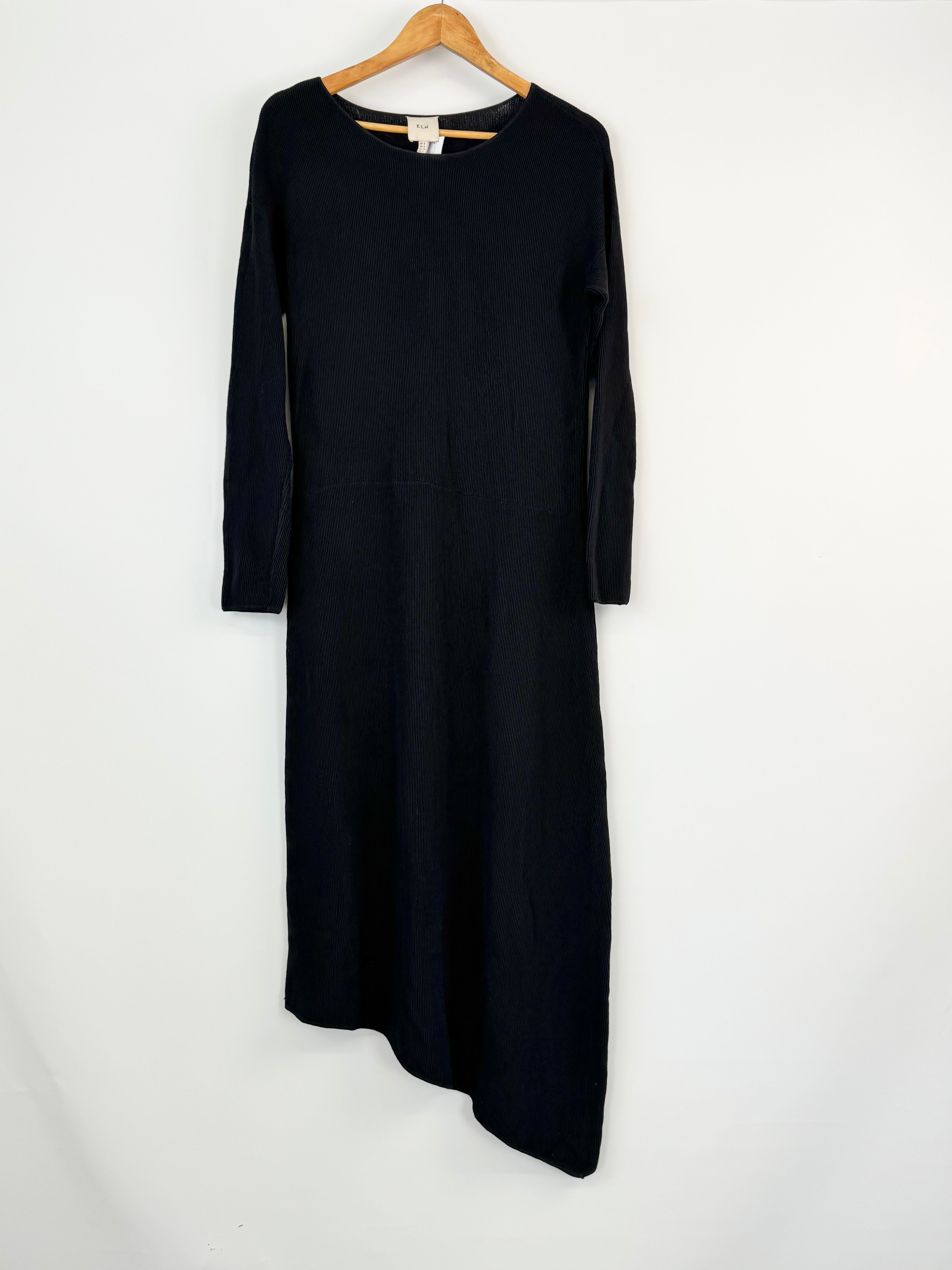 Black dress on a hanger against a white background