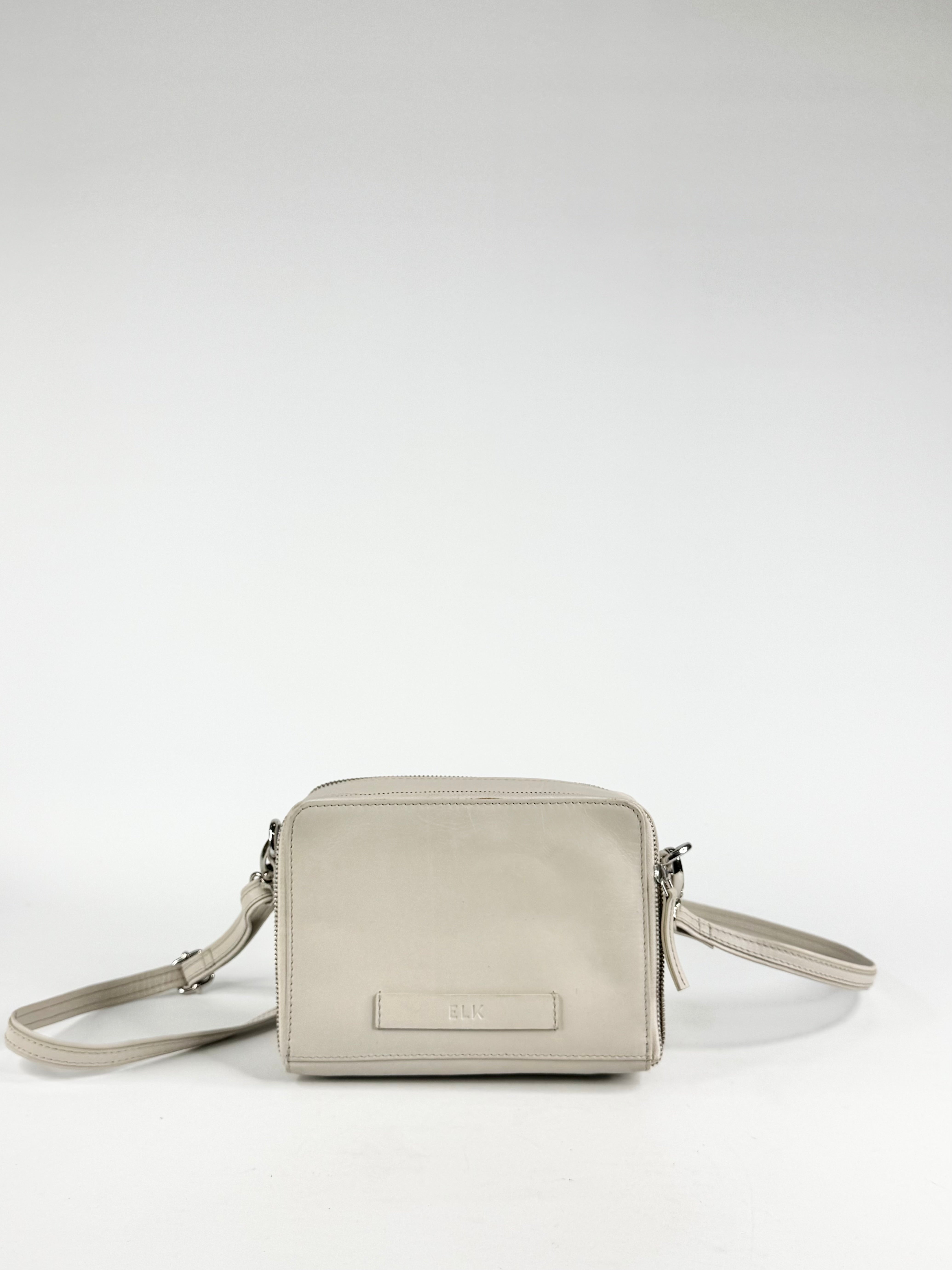 Light gray crossbody bag on a white background