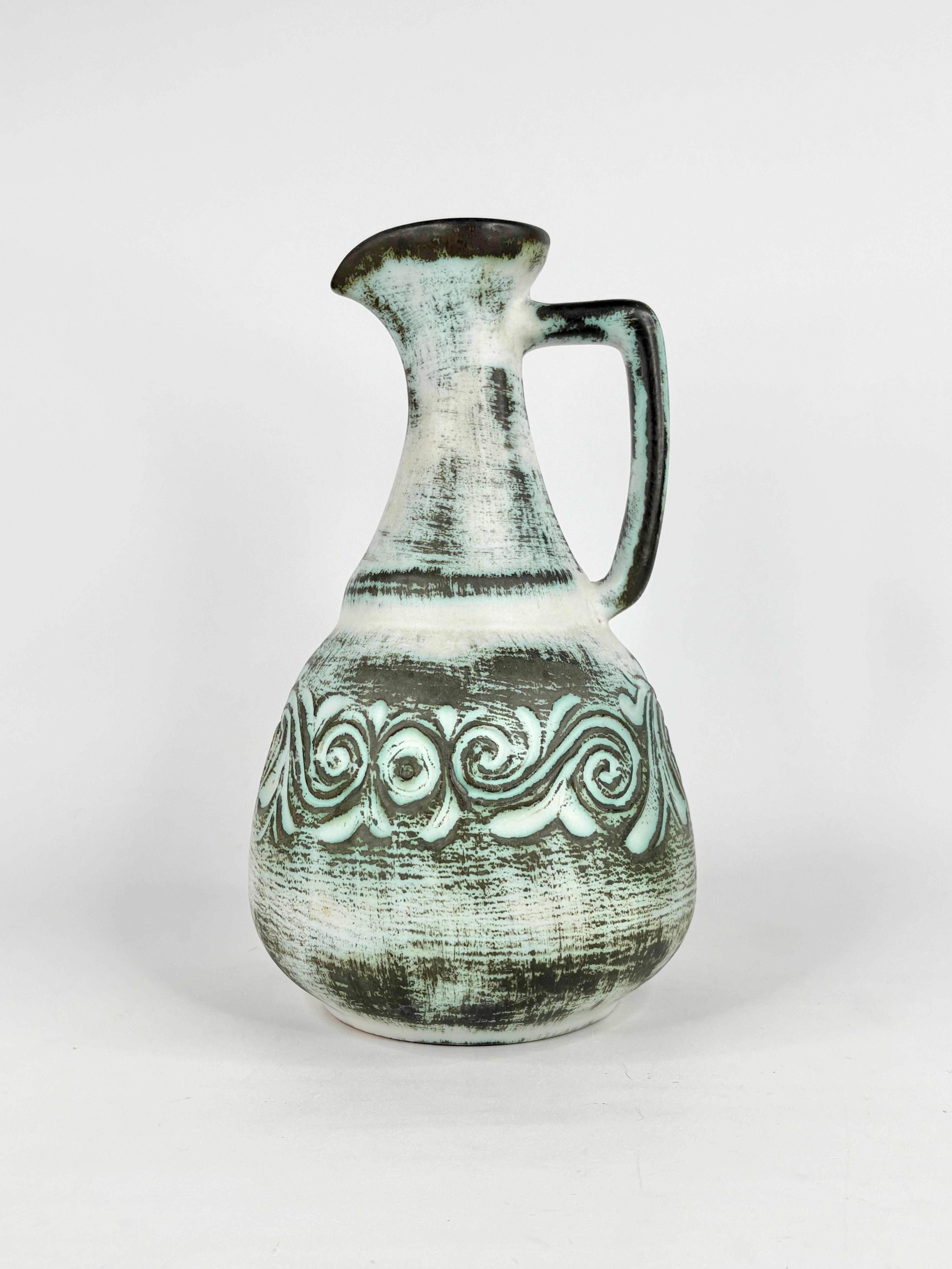 Ceramic pitcher with decorative patterns on a white background