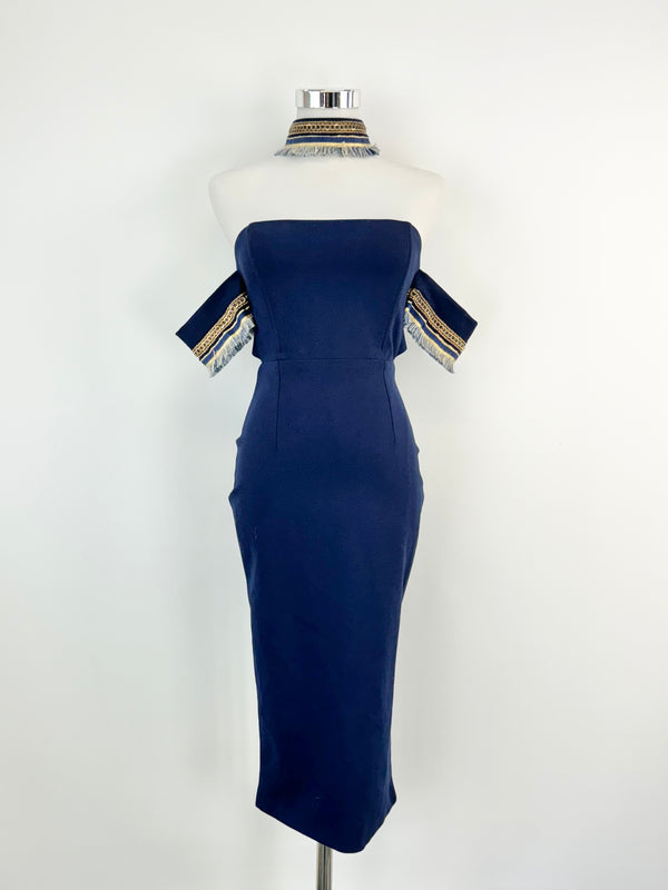 A navy blue midi dress with gold embellishments on the sleeves, displayed on a mannequin.