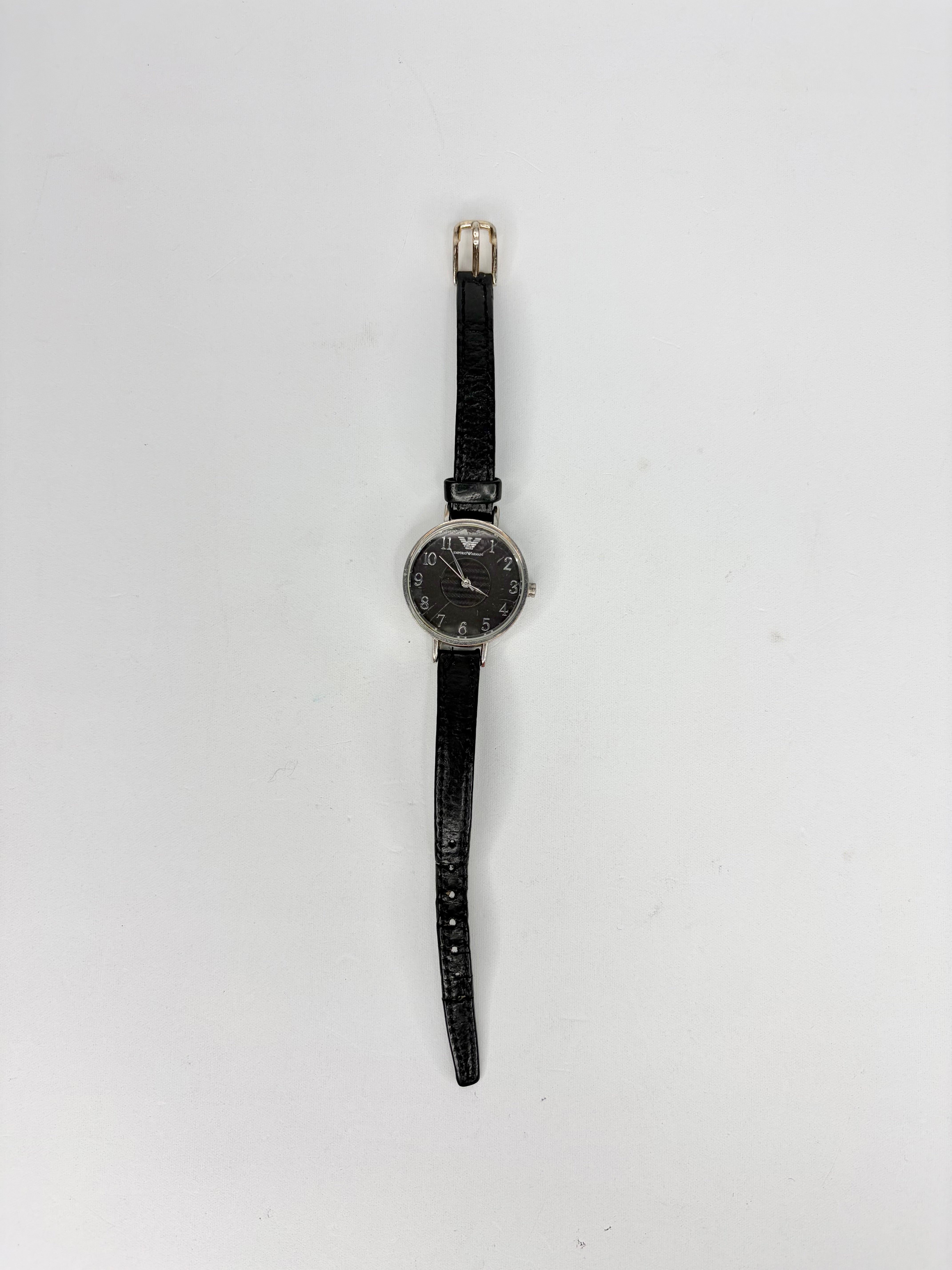 Black wristwatch with a plain background