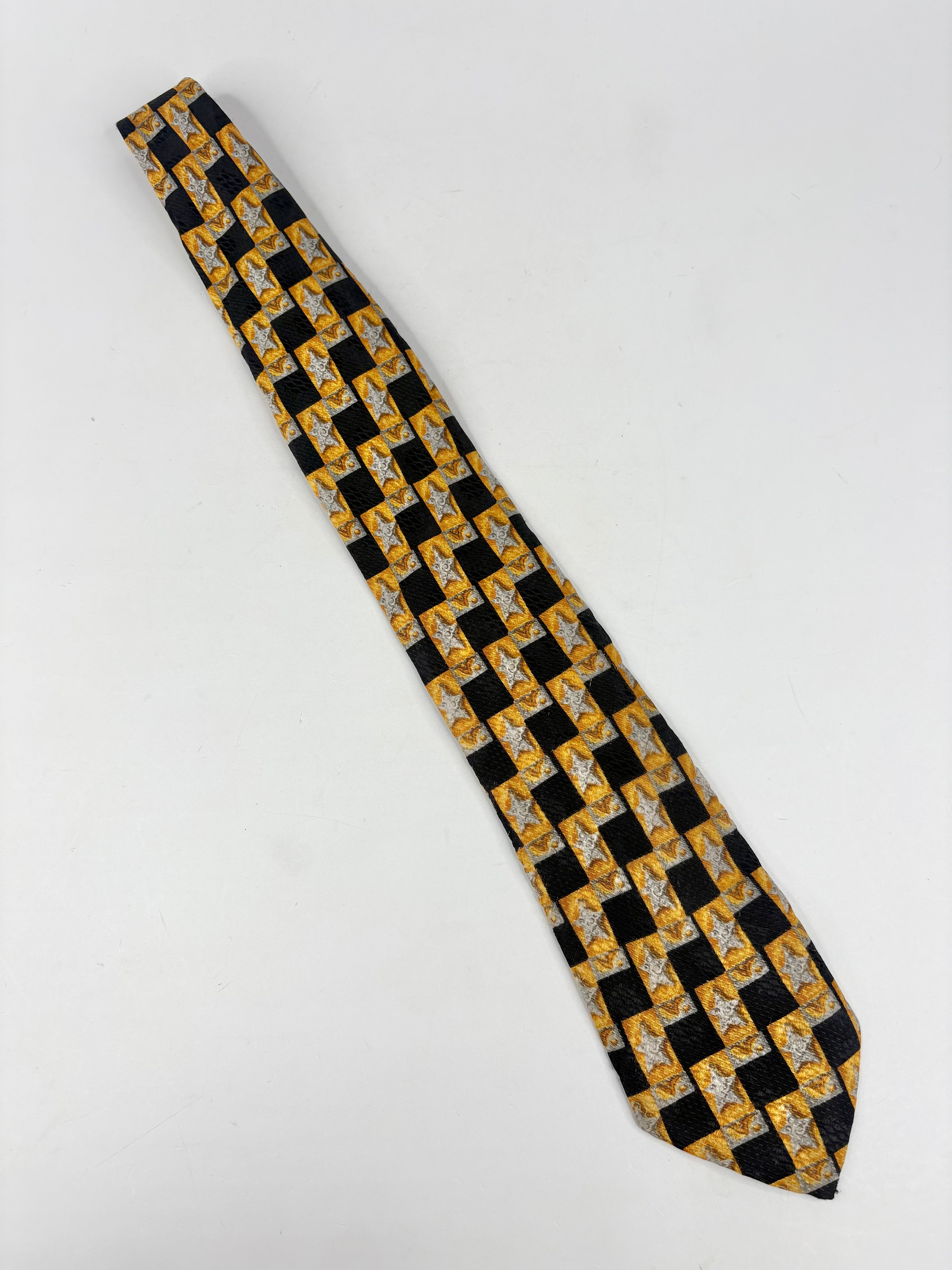 Black and gold checkered tie on a white background